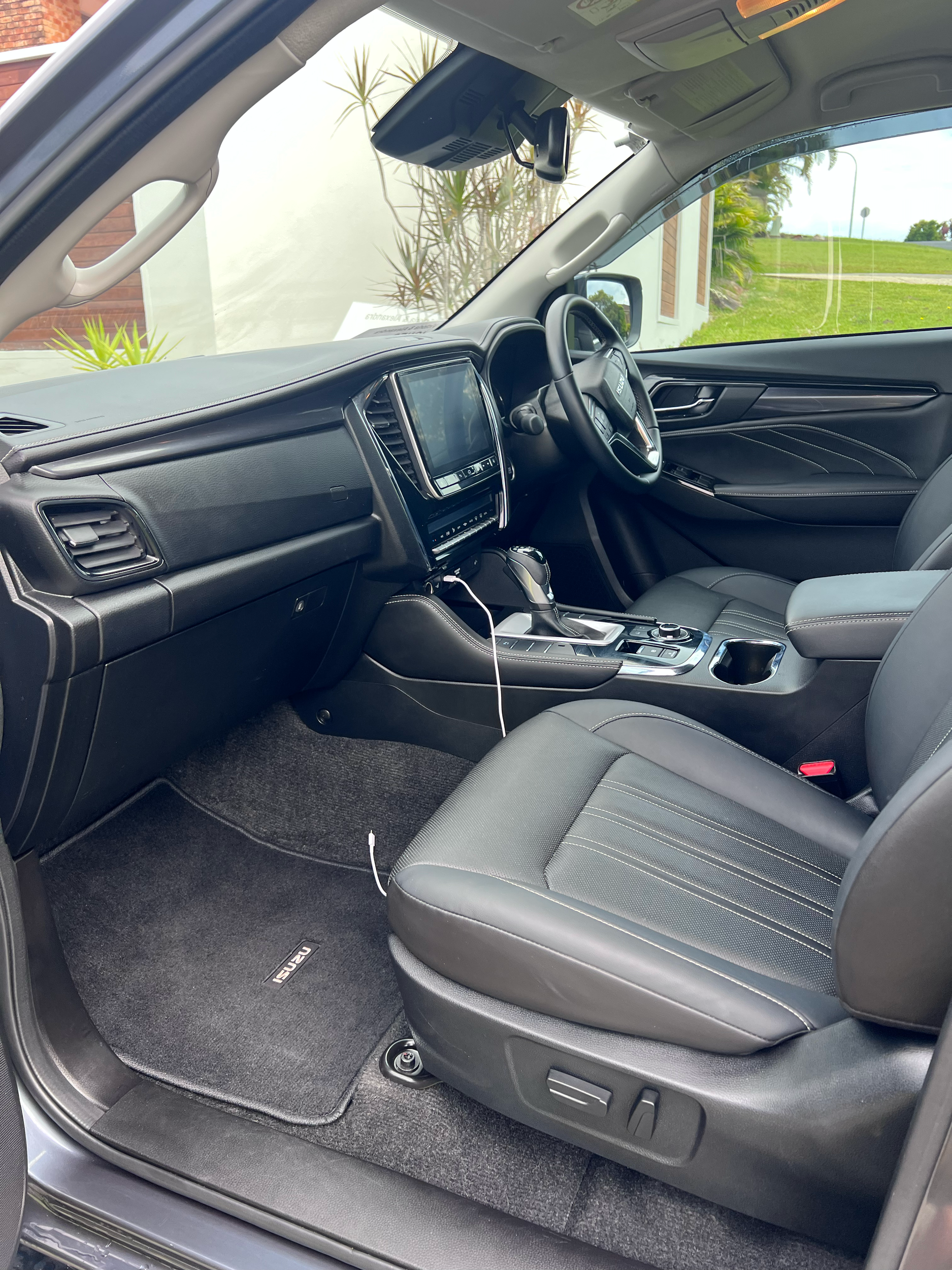Freshly detailed car interior in Coffs Harbour, showing spotless seats, polished dashboard, and clean floor mats under natural light.