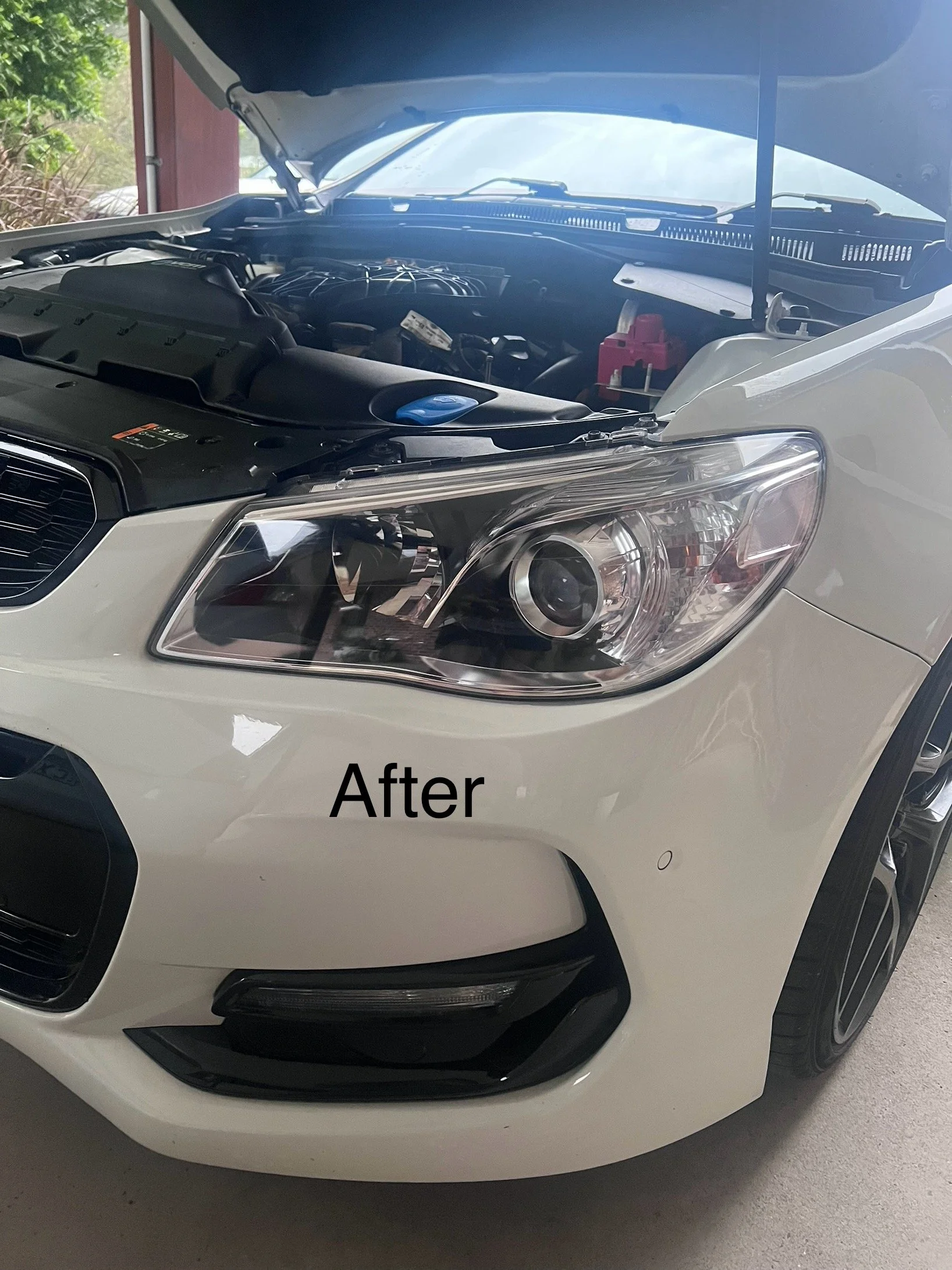White car with its hood open showing the engine compartment. The front bumper and headlight are visible, with the word 'After' overlaid on the image.
