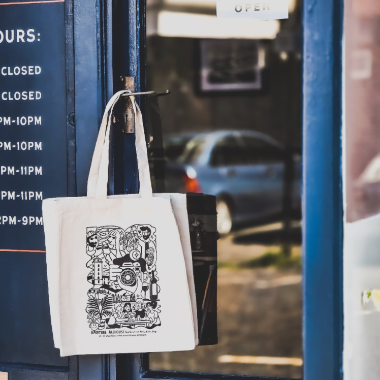 Cotton canvas tote bag with an illustration designed by Laura Sheldon and printed using the eco-friendly direct-to-garment process by Lyoness Press at local business Aperture Alehouse in North Shields.