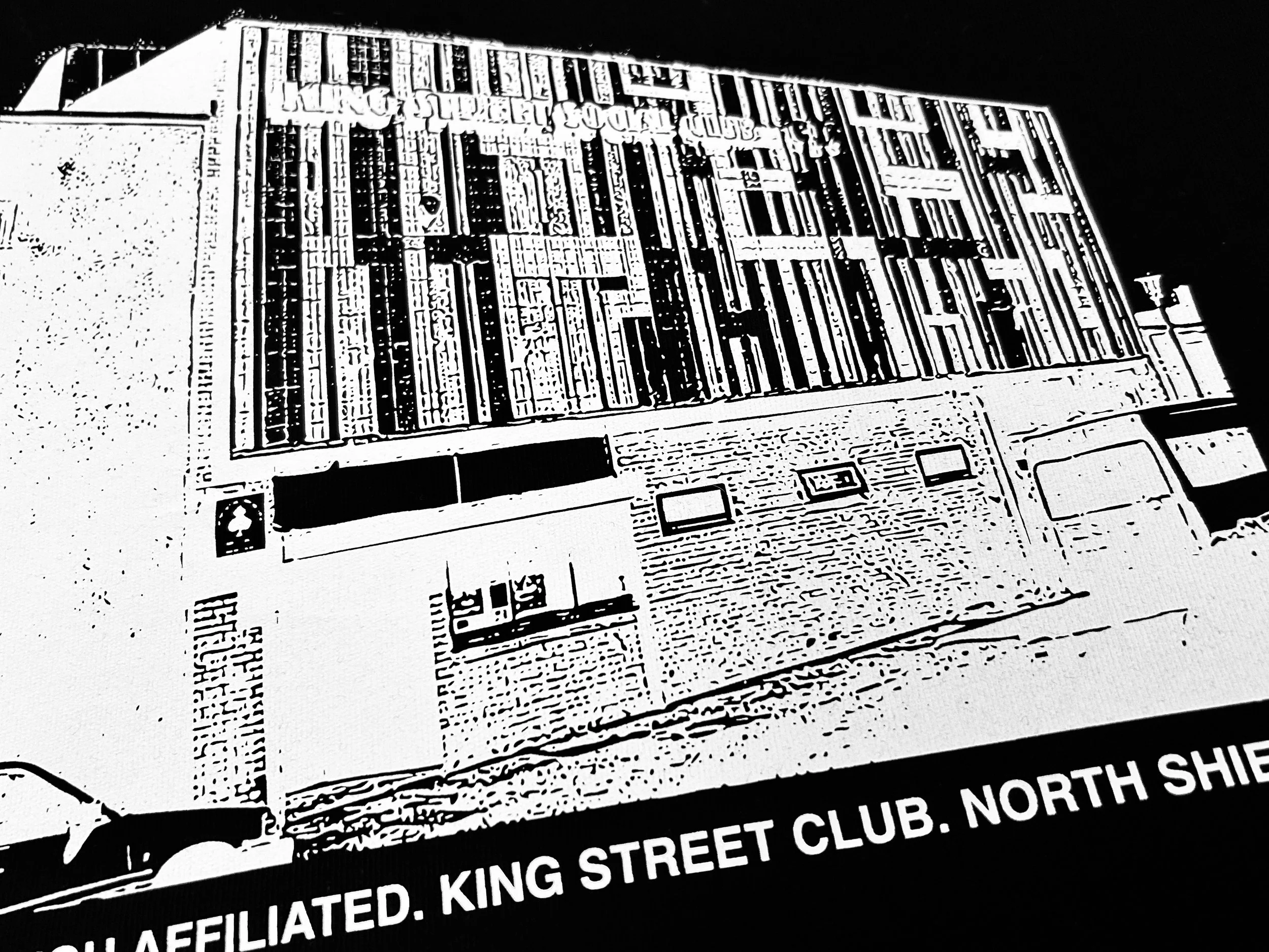 Stahls 1-5 screen-printed transfer of Are You Affiliated club venue, King Street Social Club in North Shields, on a black T-shirt. Produced by Lyoness Press printing studio.
