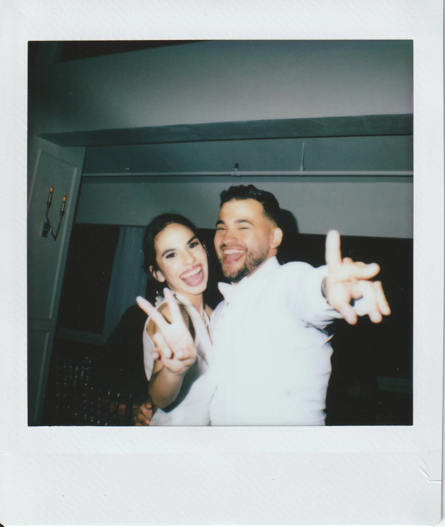 A polaroid instant film photo of newly wedded couple smiling at the camera on their wedding reception at a Marriott hotel in Puerto Rico