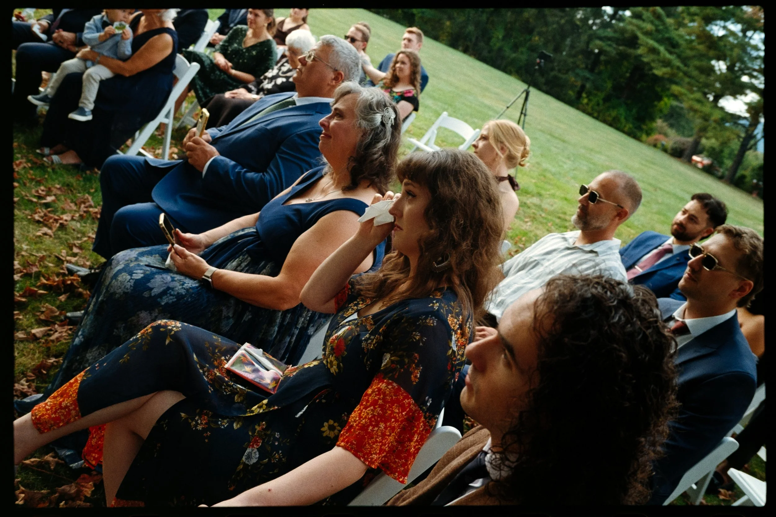 Honest, true and genuine wedding moment of a wedding guest crying after the bride walks down the aisle captured on analog film by a Photographer based in Puerto Rico