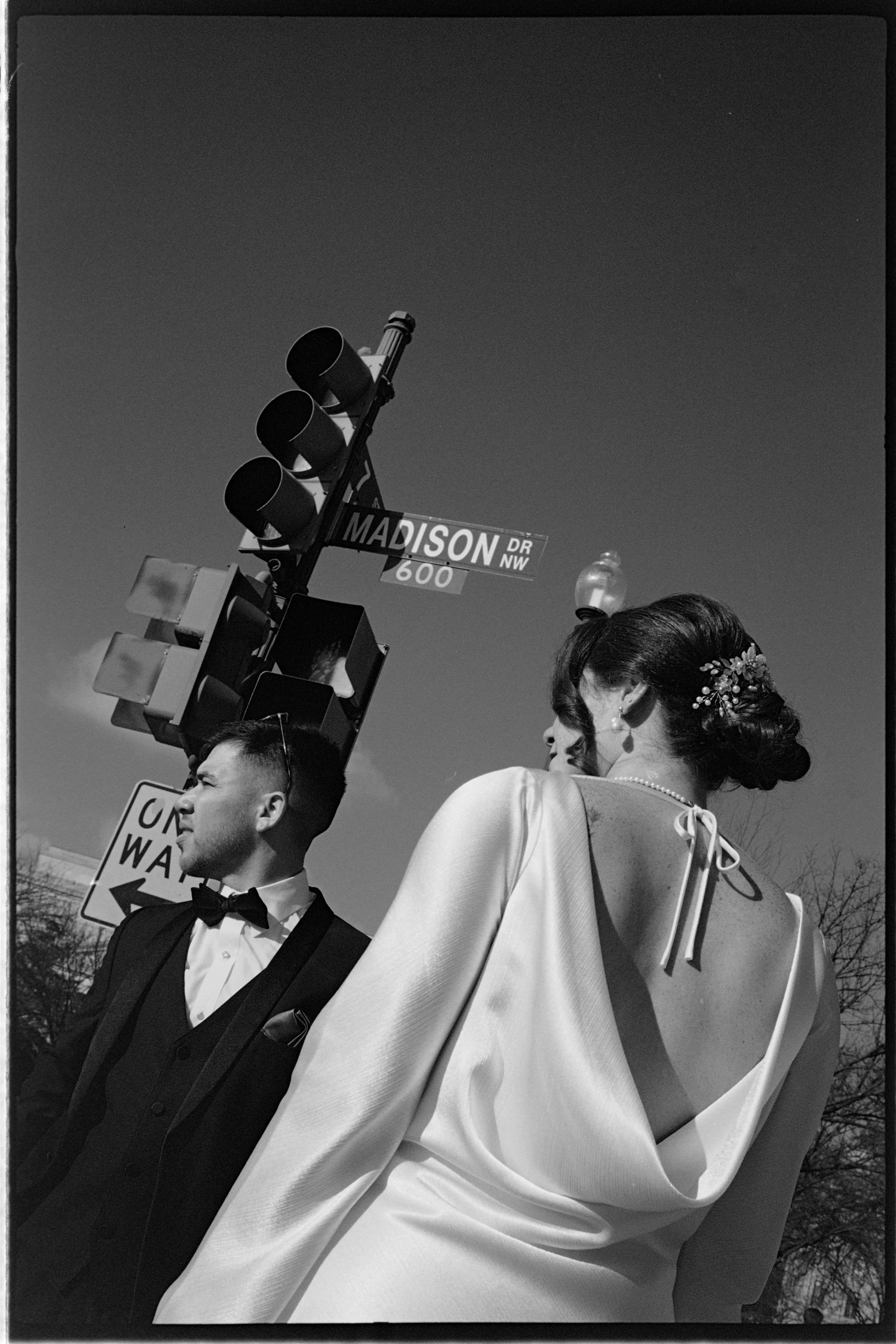 A true candid memory of a newly married couple waiting by the street taken by Puerto Rico based wedding film elopement photographer