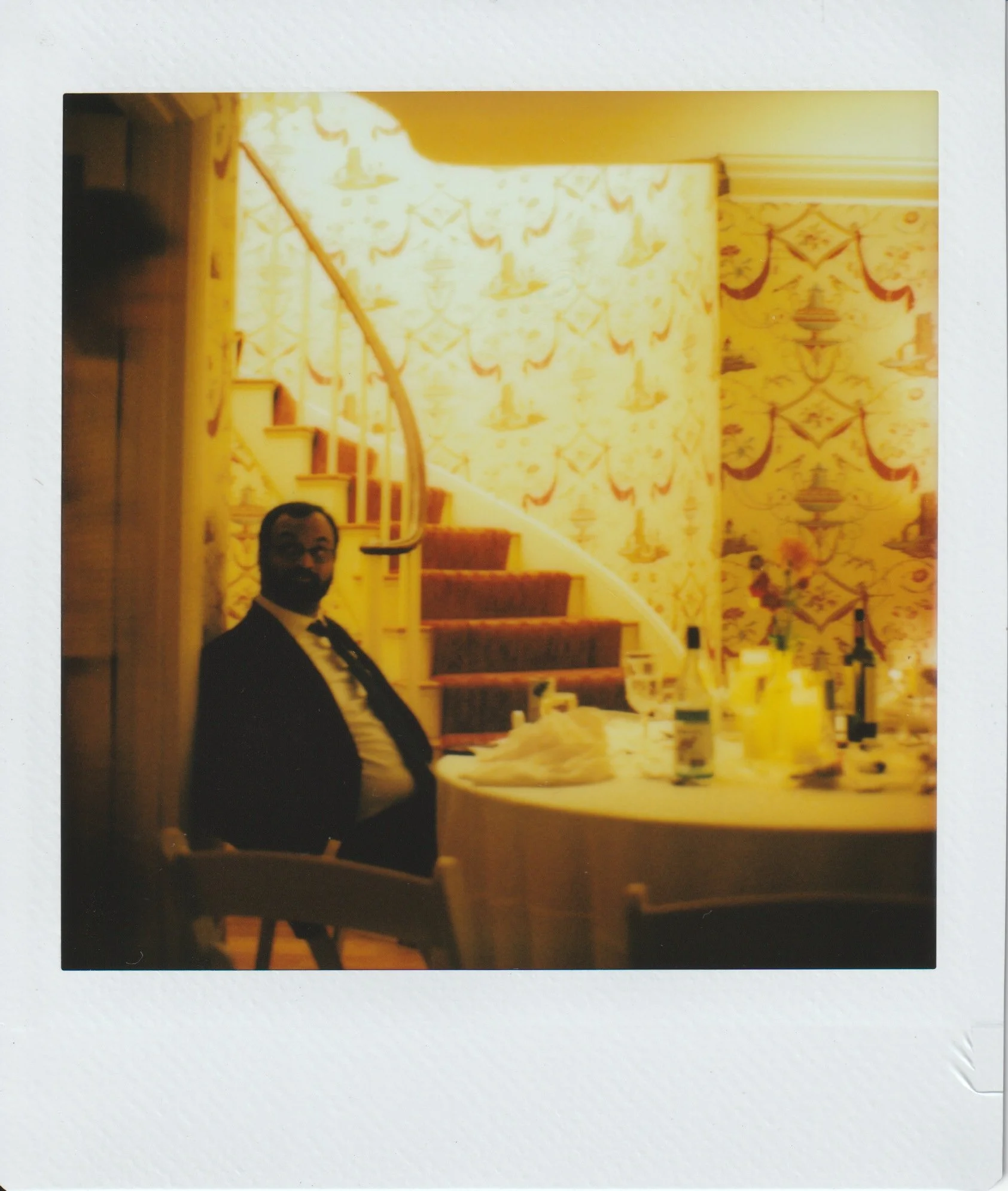 A timeless polaroid instant film photograph of a wedding guest after the wedding reception