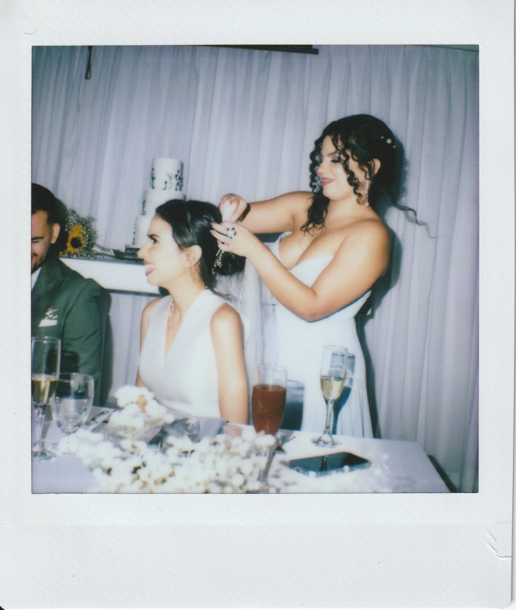 A polaroid instant film photograph of a bride and her sister helping do her hair in a Marriott Hotel in Puerto Rico