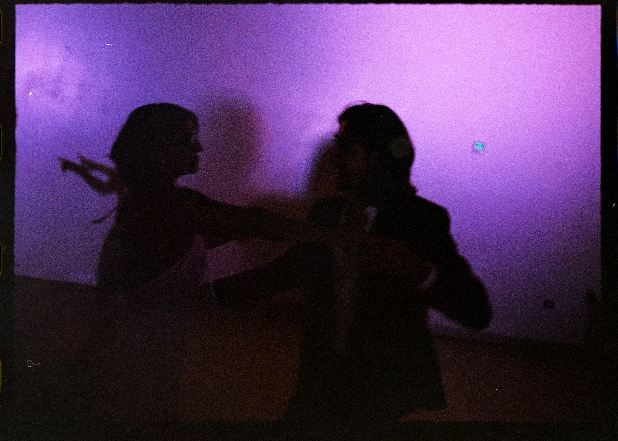 A colorful image of a newly married couple doing their first dance taken with 35mm film in Fundacion Luis Muñoz Marin wedding venue