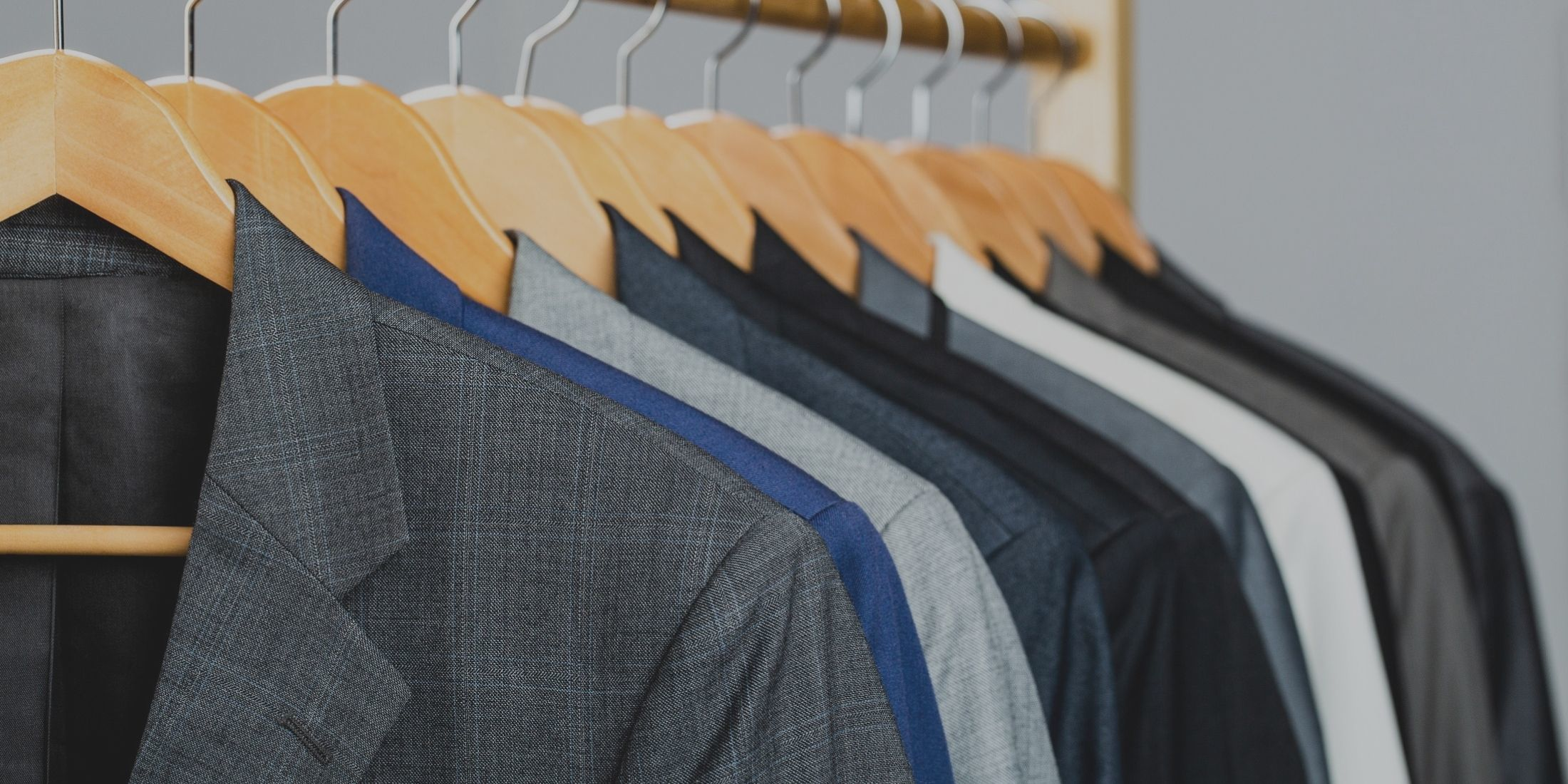 Professional dry cleaning service with garments on hangers.