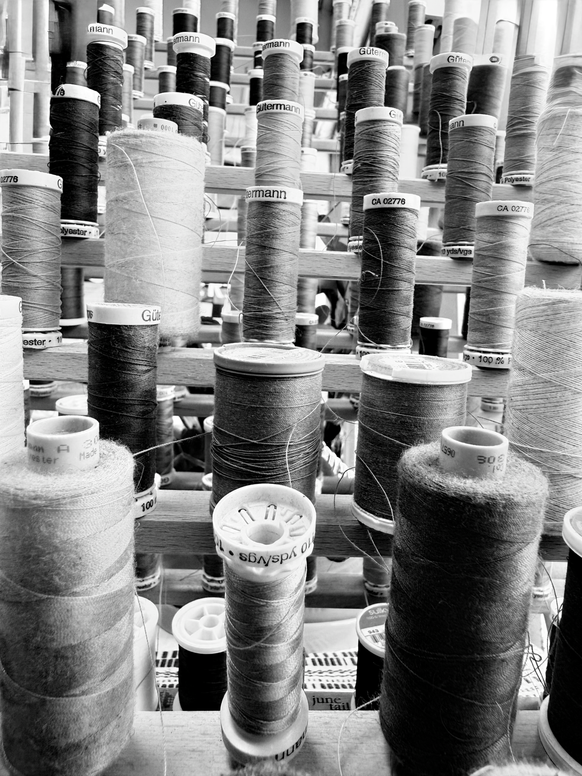 Sewing thread spools for tailoring and garment alterations.