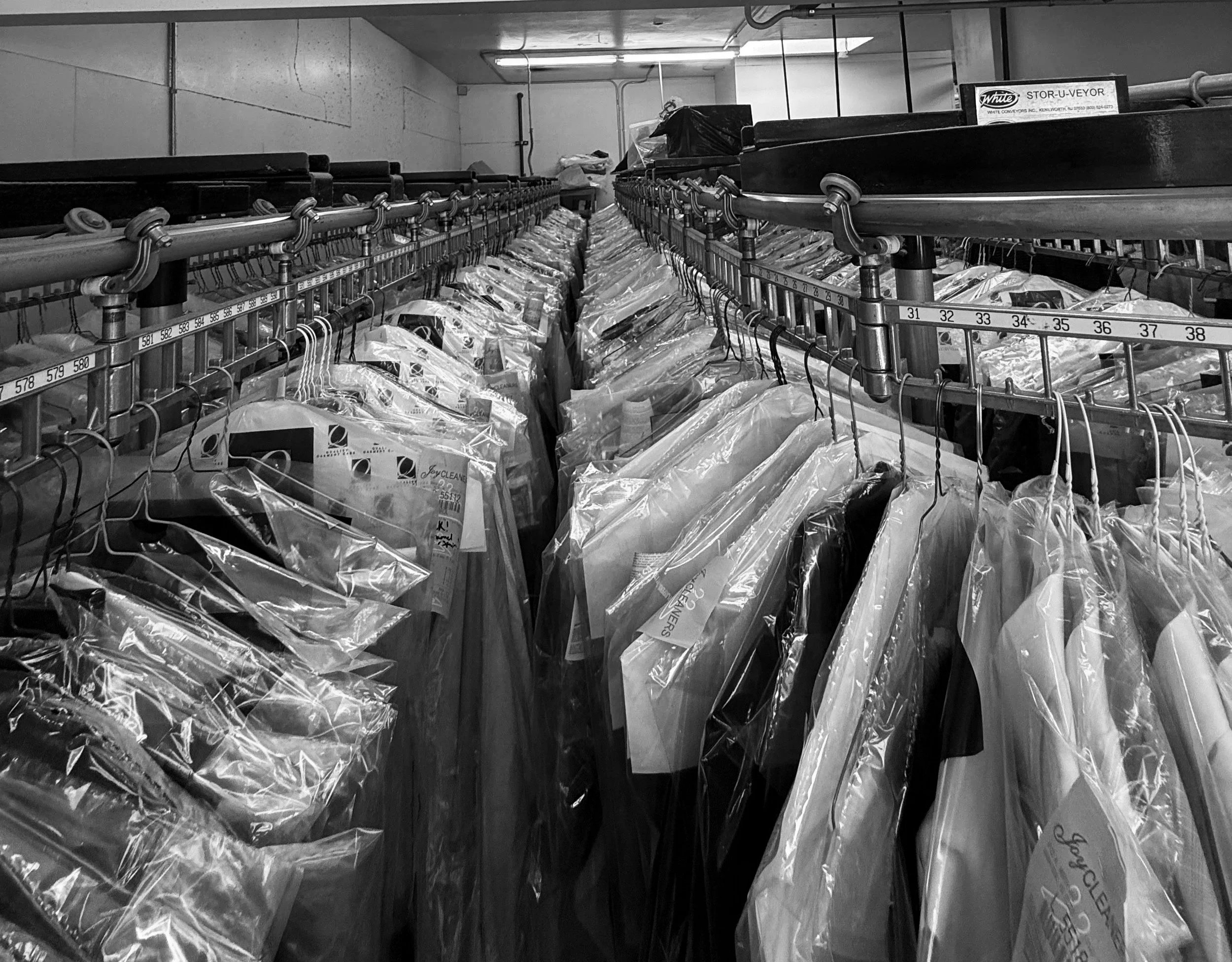 Professional dry cleaning garment racks at Joy Cleaners