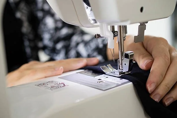 Tailoring and garment alteration work on a sewing machine.