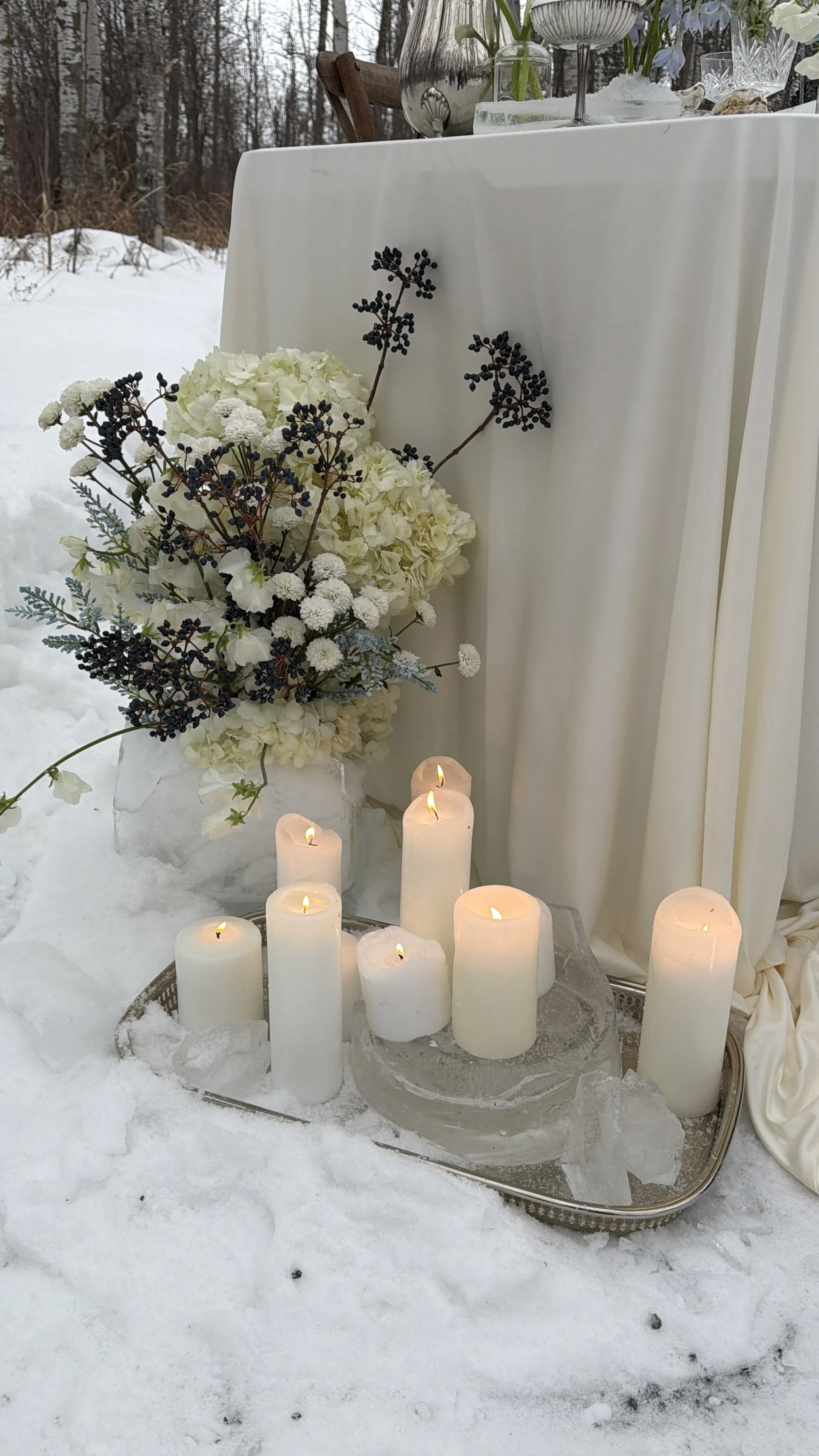 Sparrow Lane Events styled shoot table setting with elegant ivory and soft blue florals in an ice vase by Petal for Your Thoughts which created a rustic winter western charm.