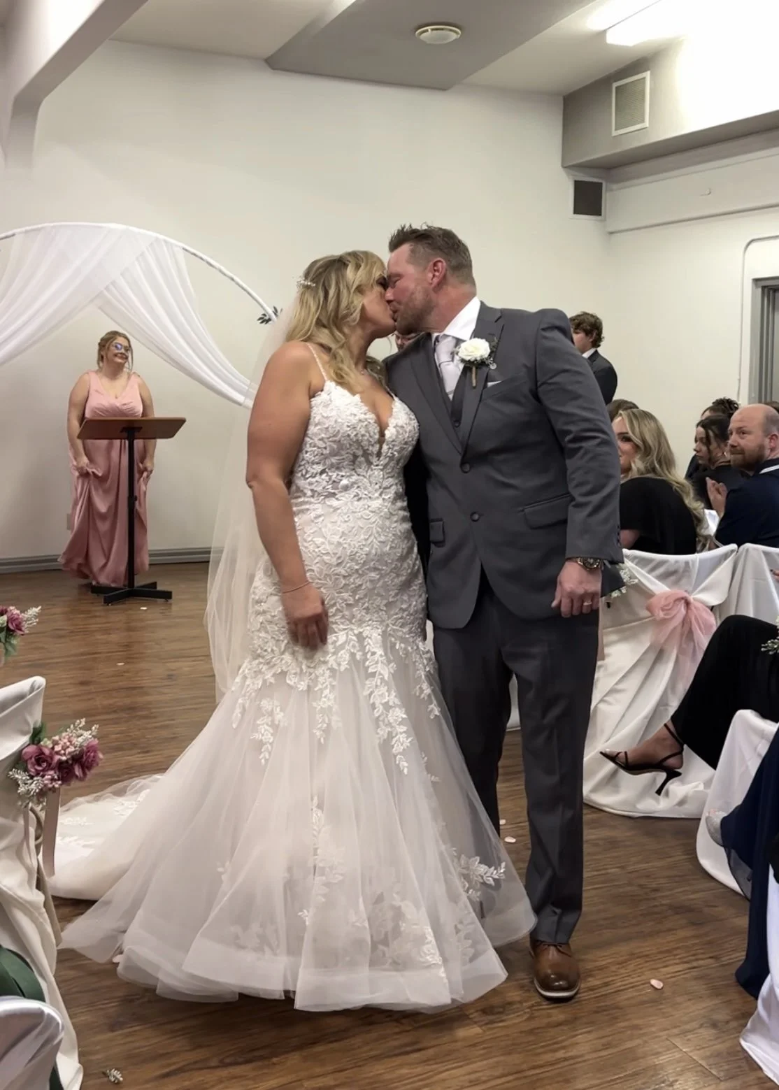 Photo of bride and groom walking back down the aisle and kissing