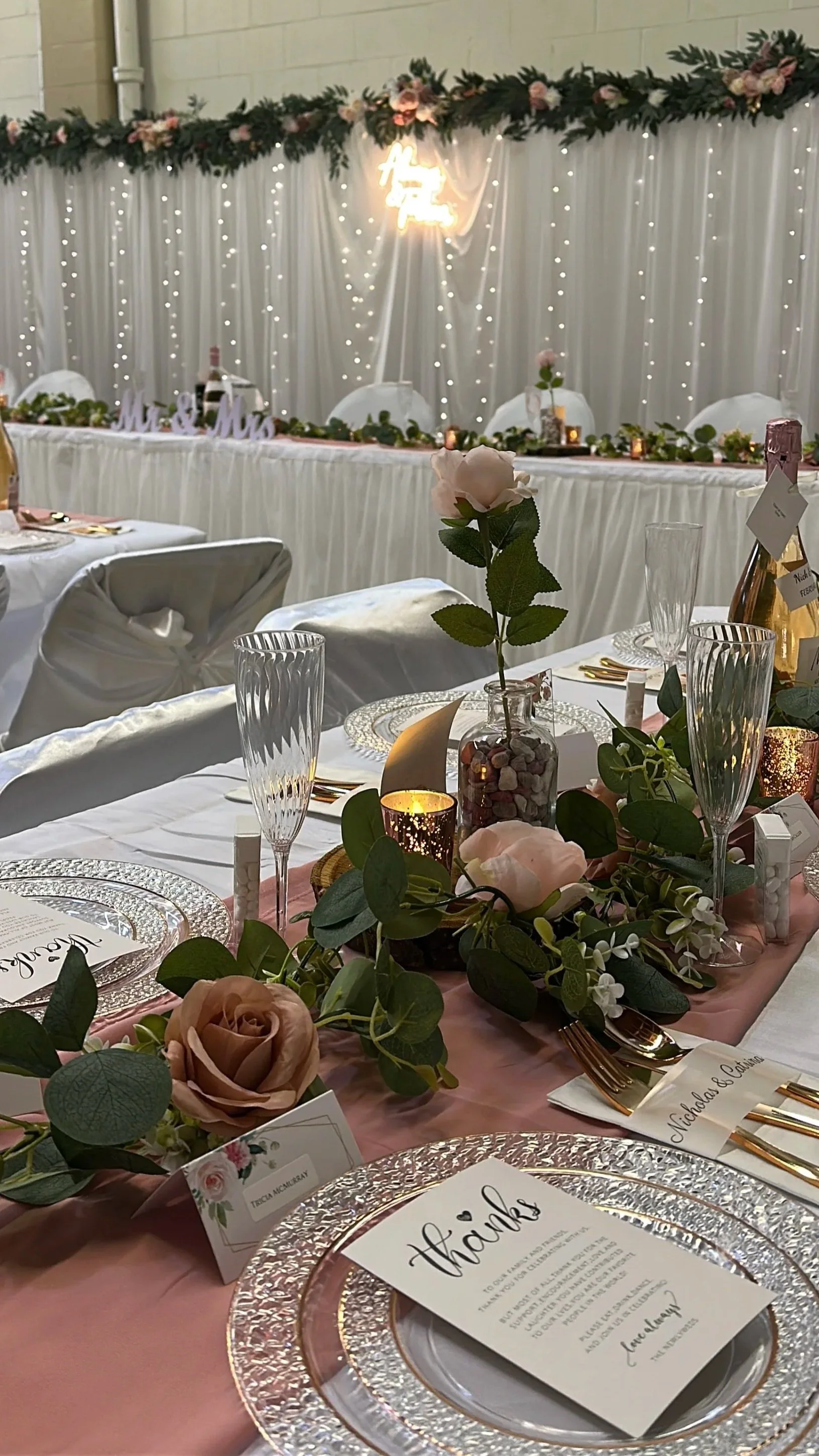 Photograph of Edmonton wedding reception tablescape and head table backdrop
