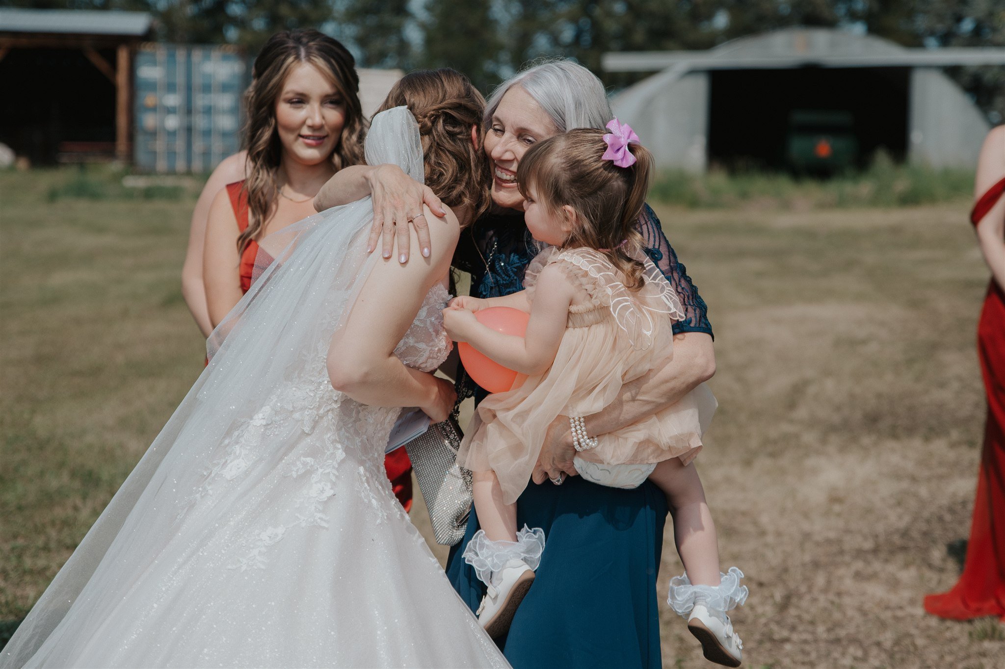 Bride sharing a special moment with her loved one at rustic Alberta wedding