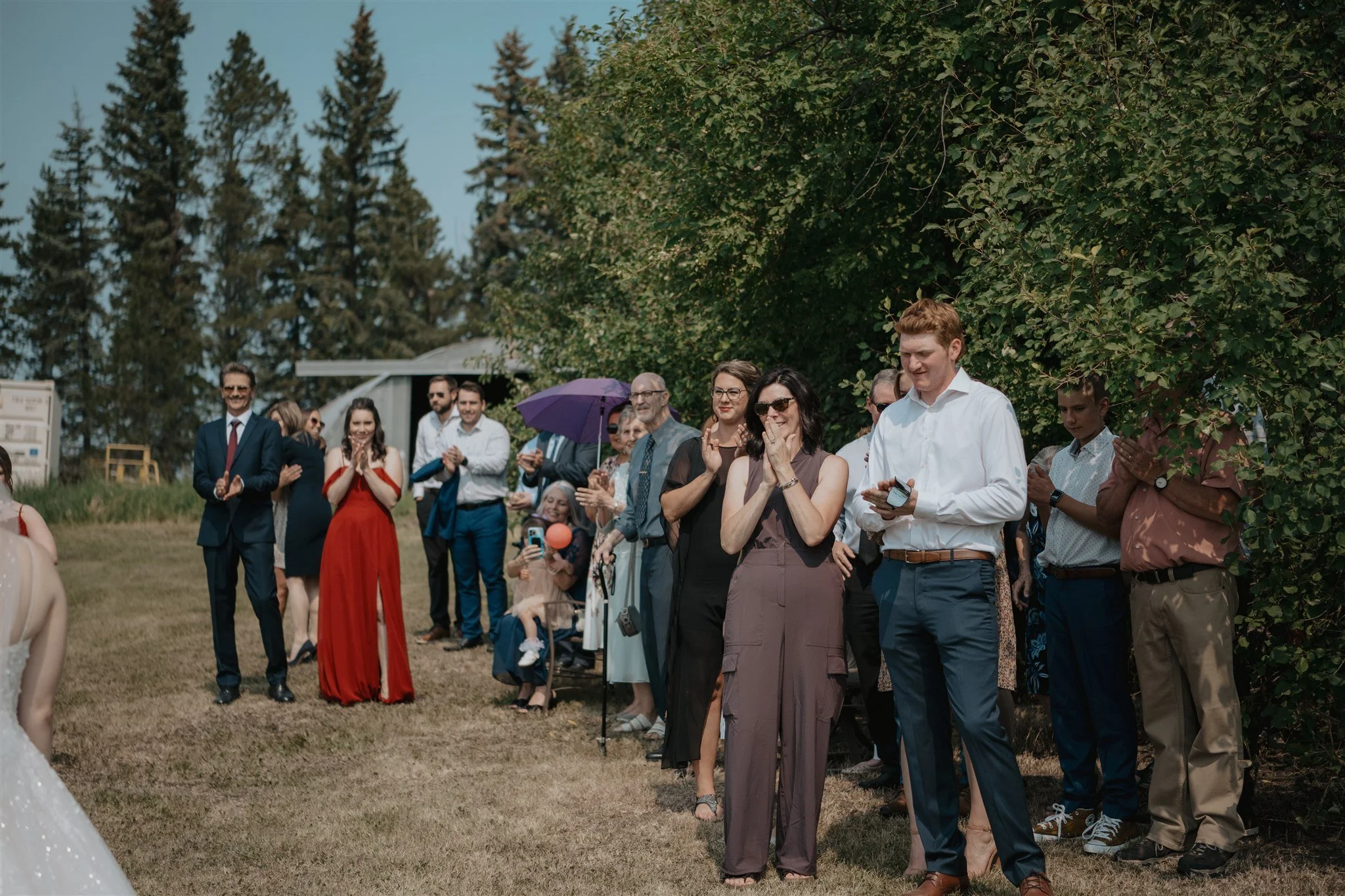 Image of guests reacting to bride and grooms outdoor first look