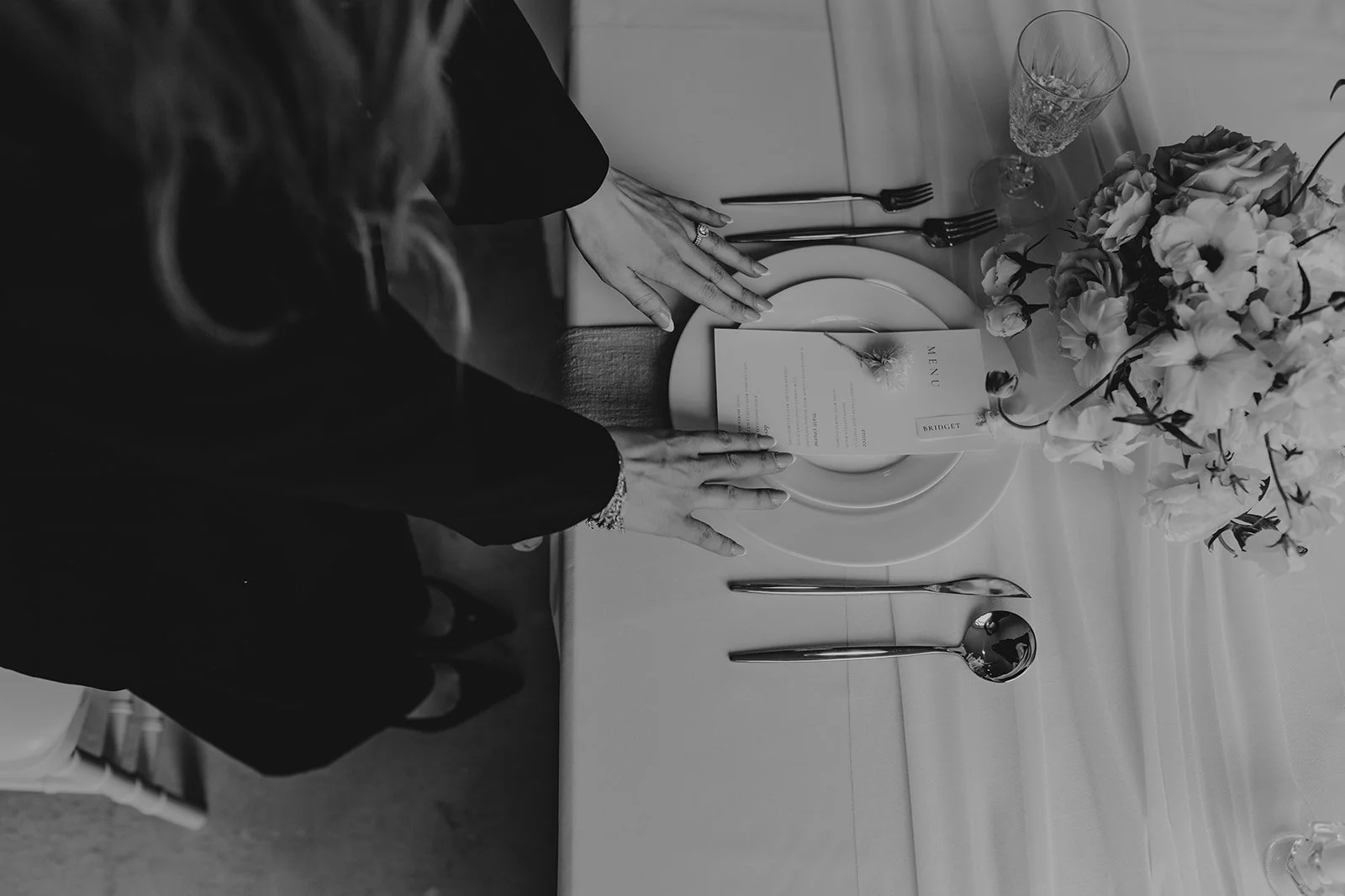 Photograph of wedding vendor fixing a table setting in Edmonton Alberta