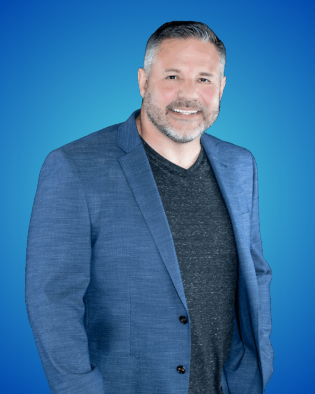 Person holding a football indoors wearing a suit