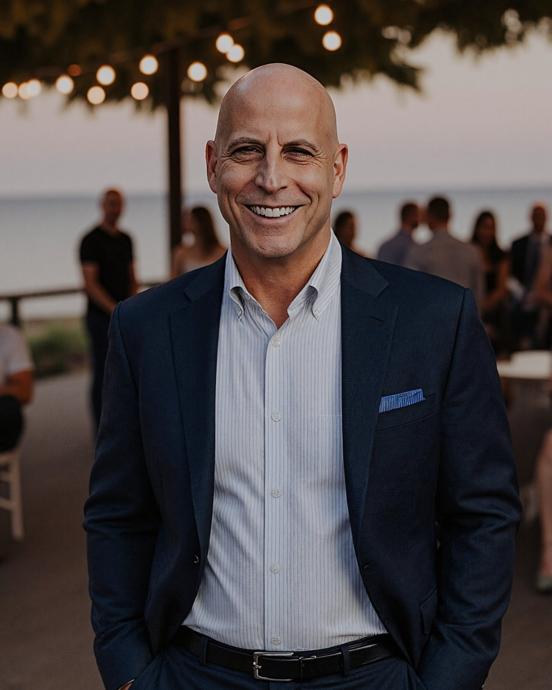 Young boy playing golf, wearing a red shirt and blue shorts, swinging a club on a green golf course.