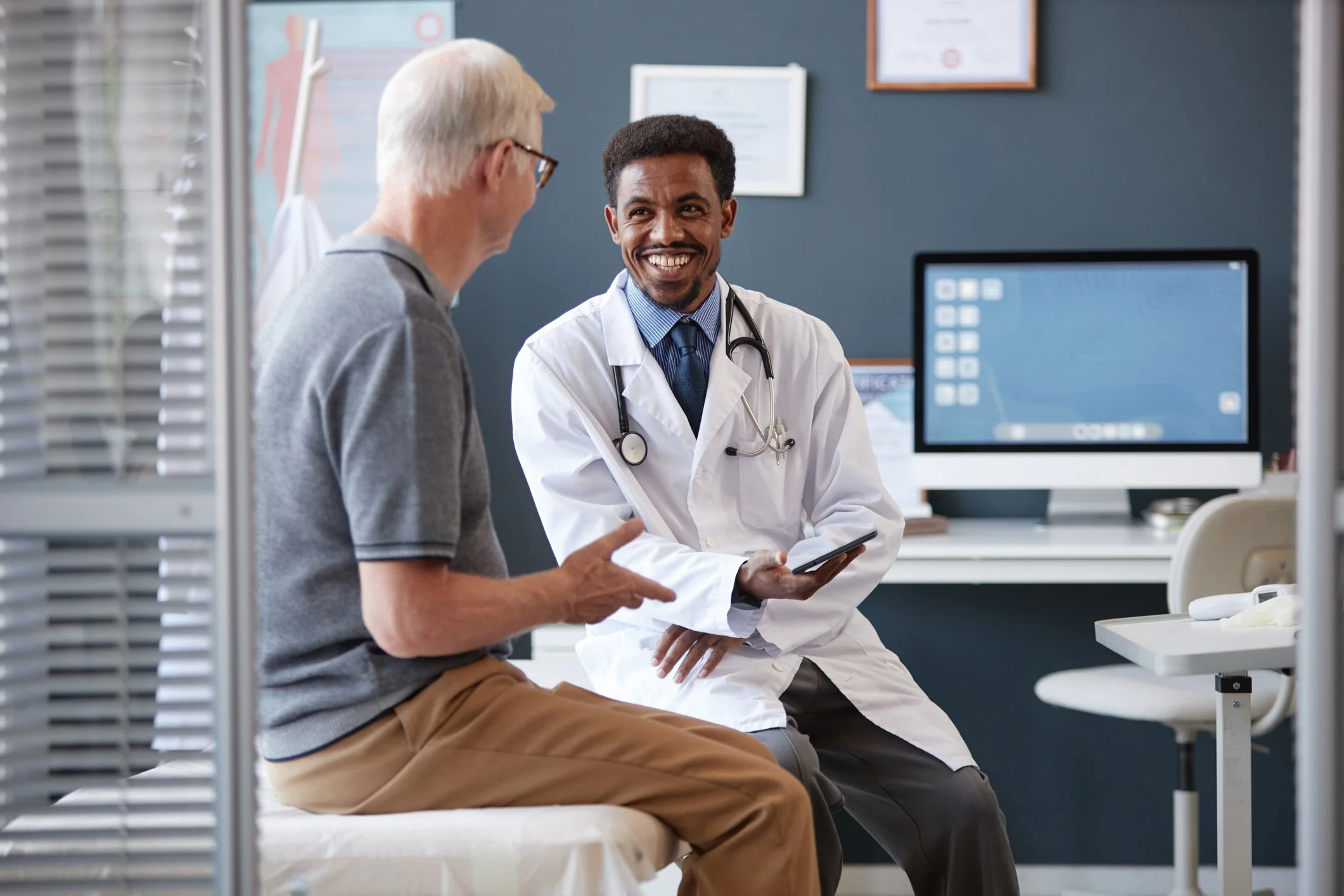 Senior patient reviewing lung cancer risk assessment with his doctor during a consultation — clinical use cases for the CIZ1B biomarker blood test
