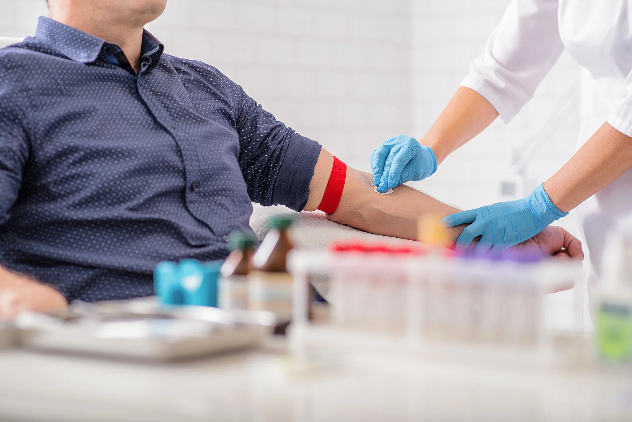 Phlebotomist collecting a blood sample from a patient as part of the CIZ1B lung cancer blood test specimen collection process.
