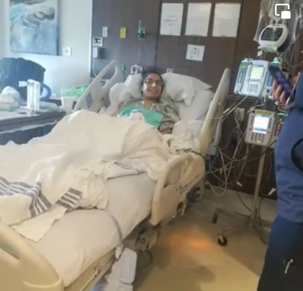 Priscilla recovering in a hospital bed after her 2019 gastrectomy, highlighting the long recovery process following surgery to reduce stomach cancer risk.