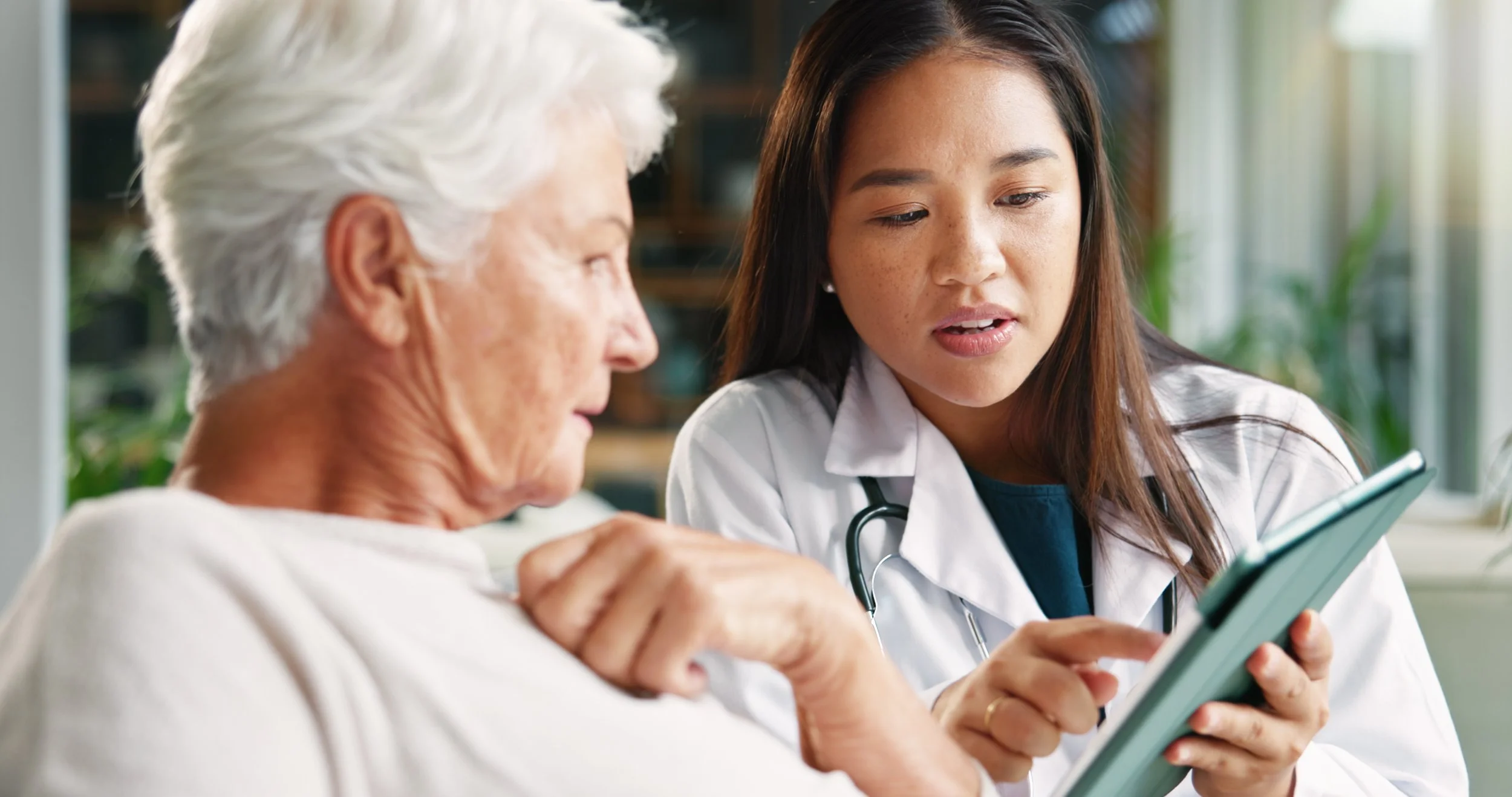 Doctor reviewing blood test results on a tablet with a patient — how providers interpret CIZ1B results alongside clinical judgment, LDCT, and patient history