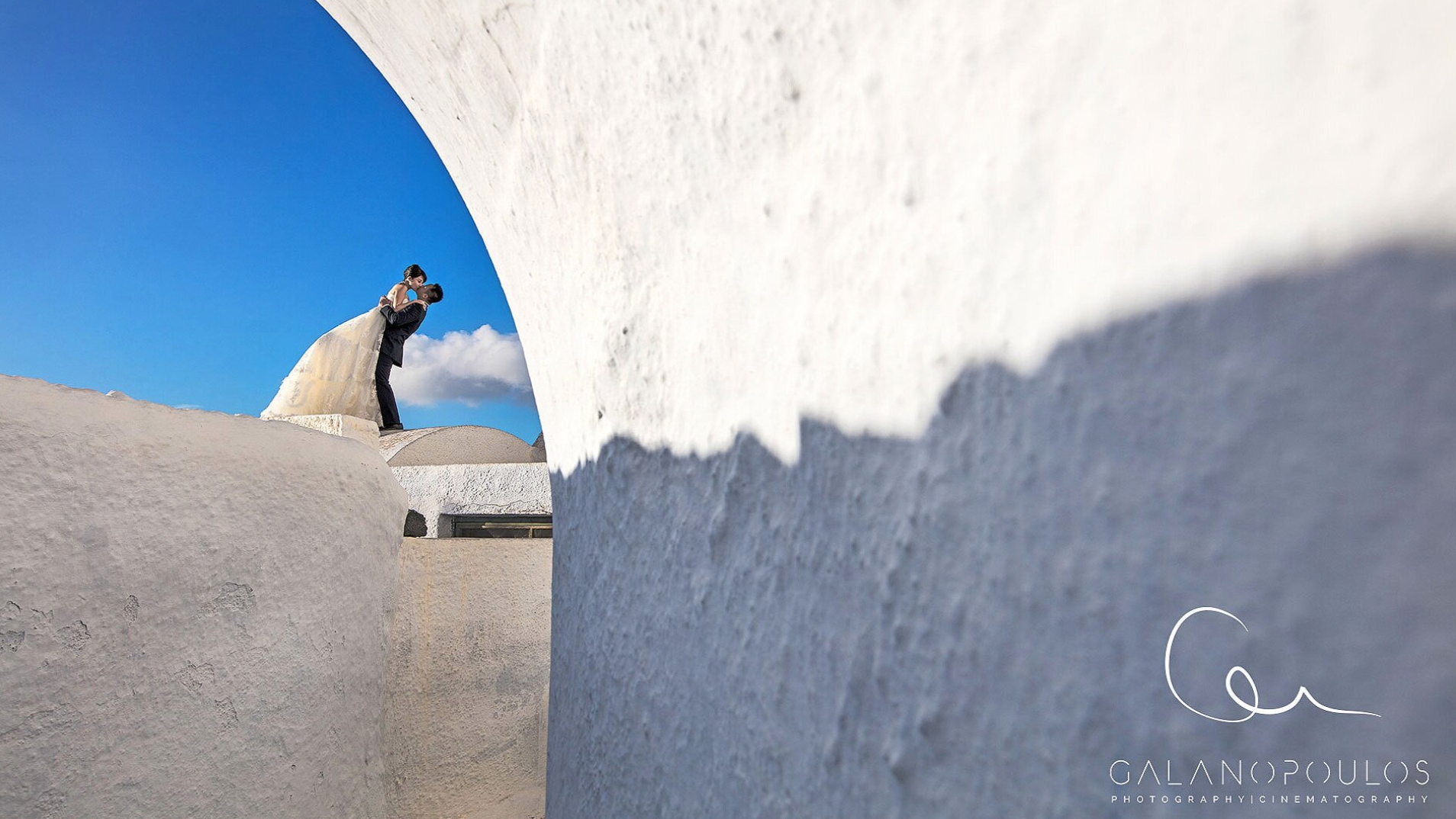 Romantic Santorini photography tour for proposals, honeymoons, and flying dress sessions with stunning sea views.