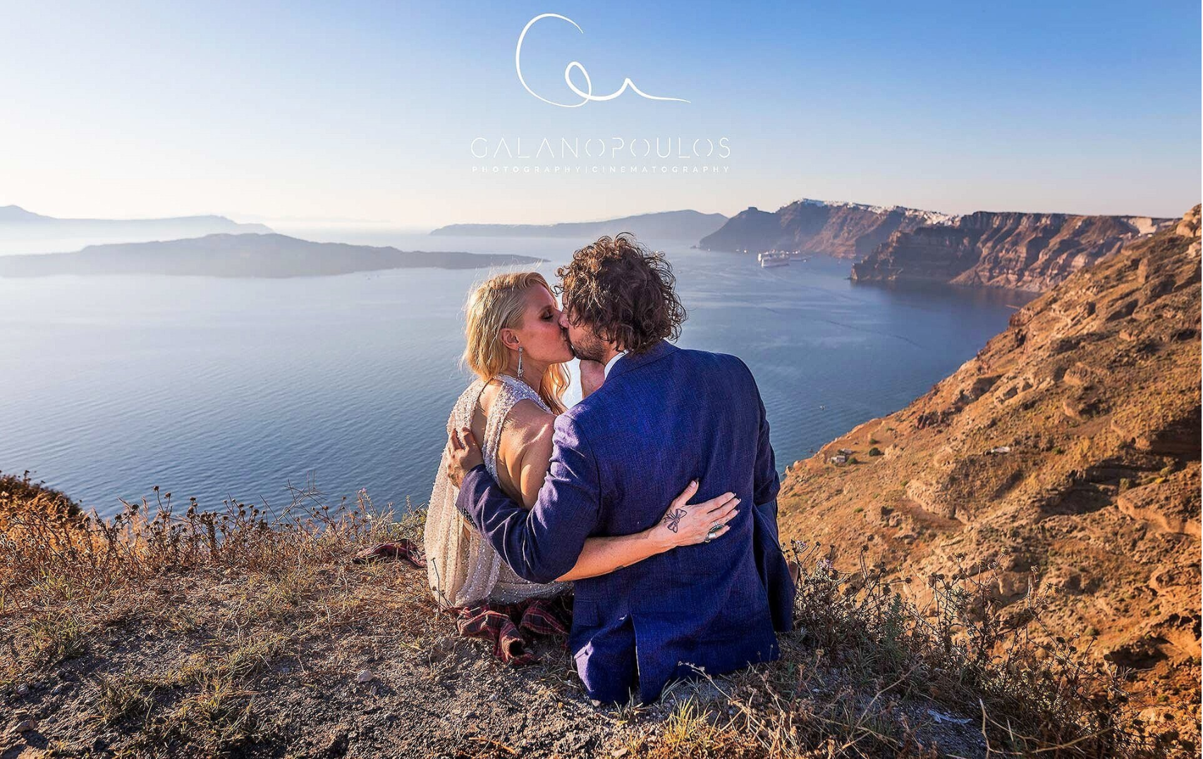 Couple enjoying honeymoon photography session in Oia, Santorini with professional guidance and high-resolution edited photos.