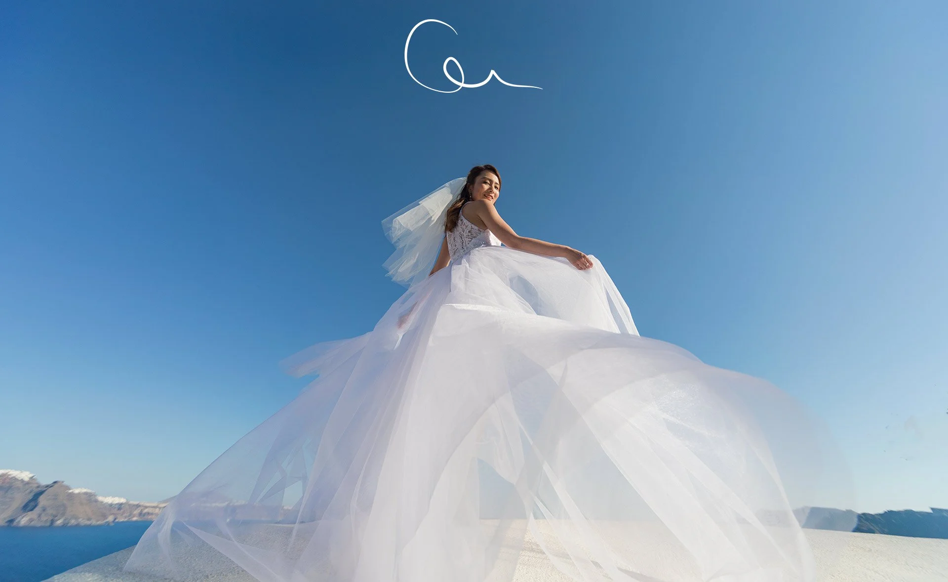 Sunset family portraits in fira overlooking the caldera and blue dome, blending santorini wedding photography, honeymoons, and beach photo shoot mood.