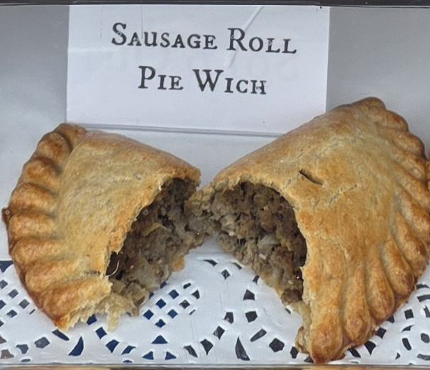 A delicious Pie Wich hand pie opened to show the ingredients, along with a card indicating the flavor.