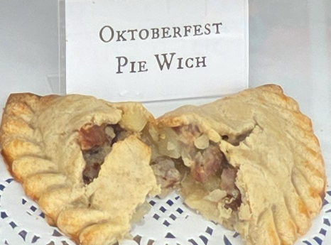 A delicious Pie Wich hand pie opened to show the ingredients, along with a card indicating the flavor.