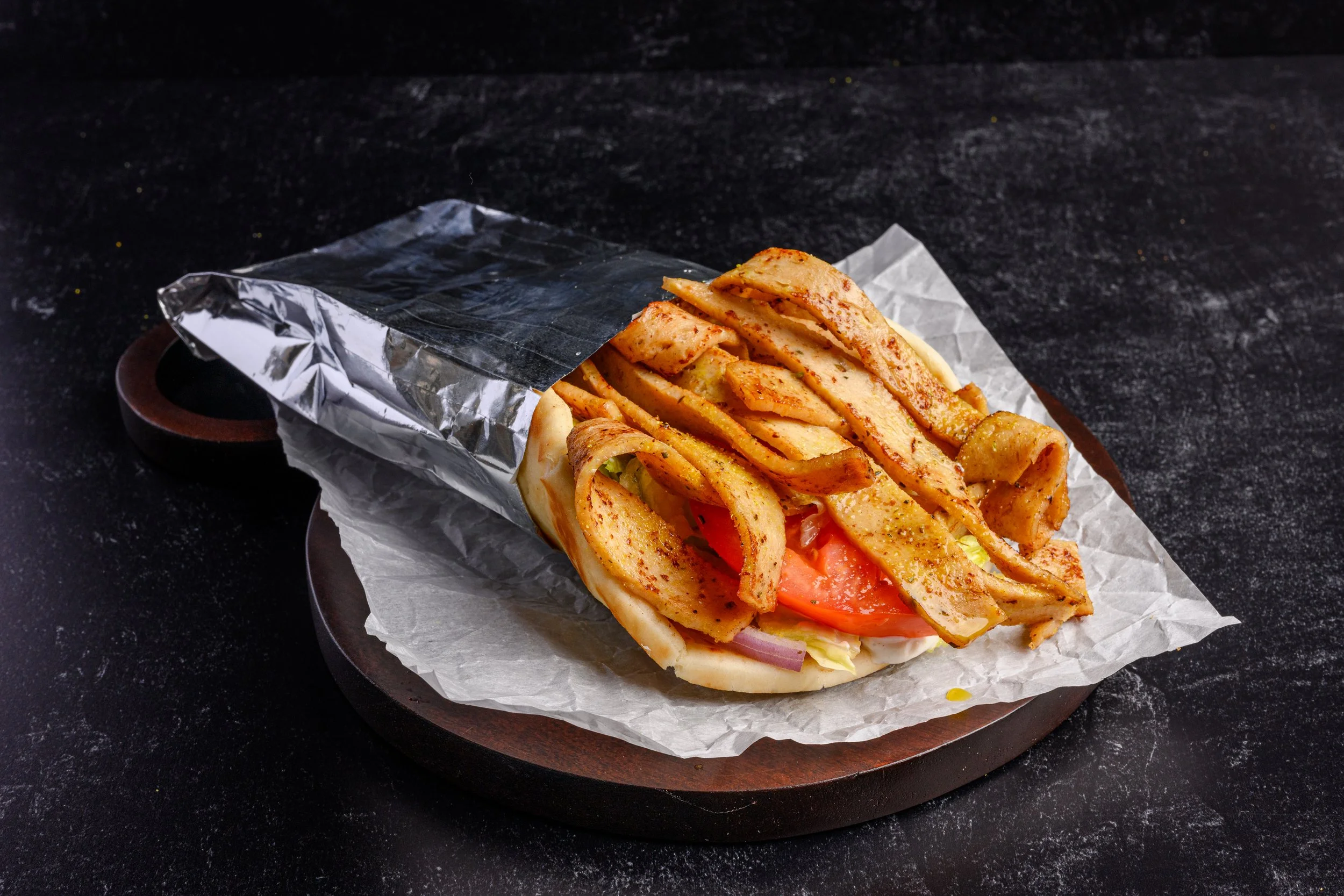 || CHICKEN GYRO SANDWICH  ||

Chicken Gyro Meat, Red Onion, Tomato, Iceberg Lettuce, and Our House Made Tzatziki Sauce Topped with Our Signature Lemon Zest - All Wrapped Into a 7" Pita Bread. 

* Gluten Contained in Pita Bread *