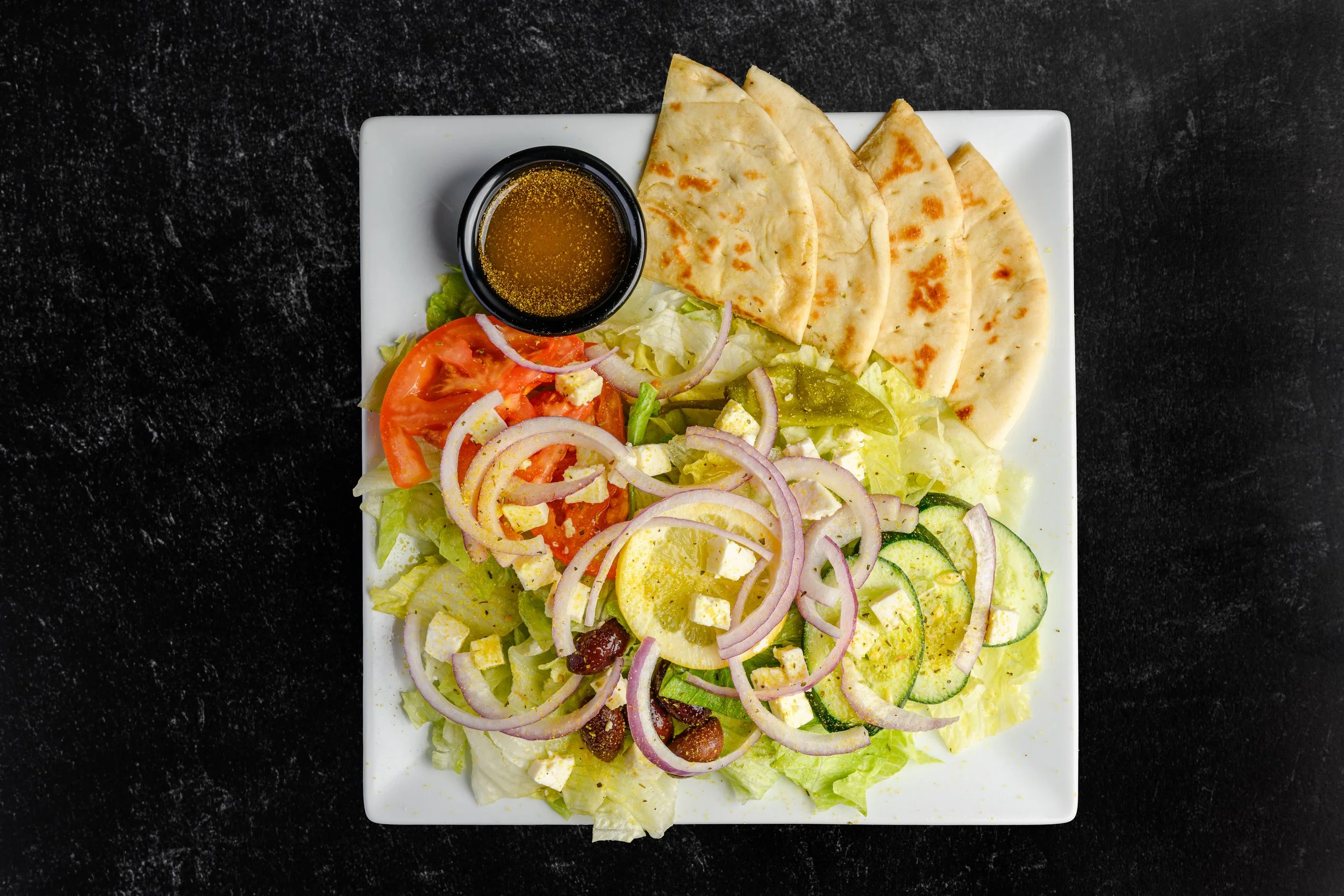 || #10 LARGE GREEK SALAD || Iceberg Lettuce + Tomato + Cucumber + Lemon + Unpitted Greek Olives + Pepperoncini + Feta Cheese + Red Onion + Pita Bread + W/ House Made Greek Dressing 