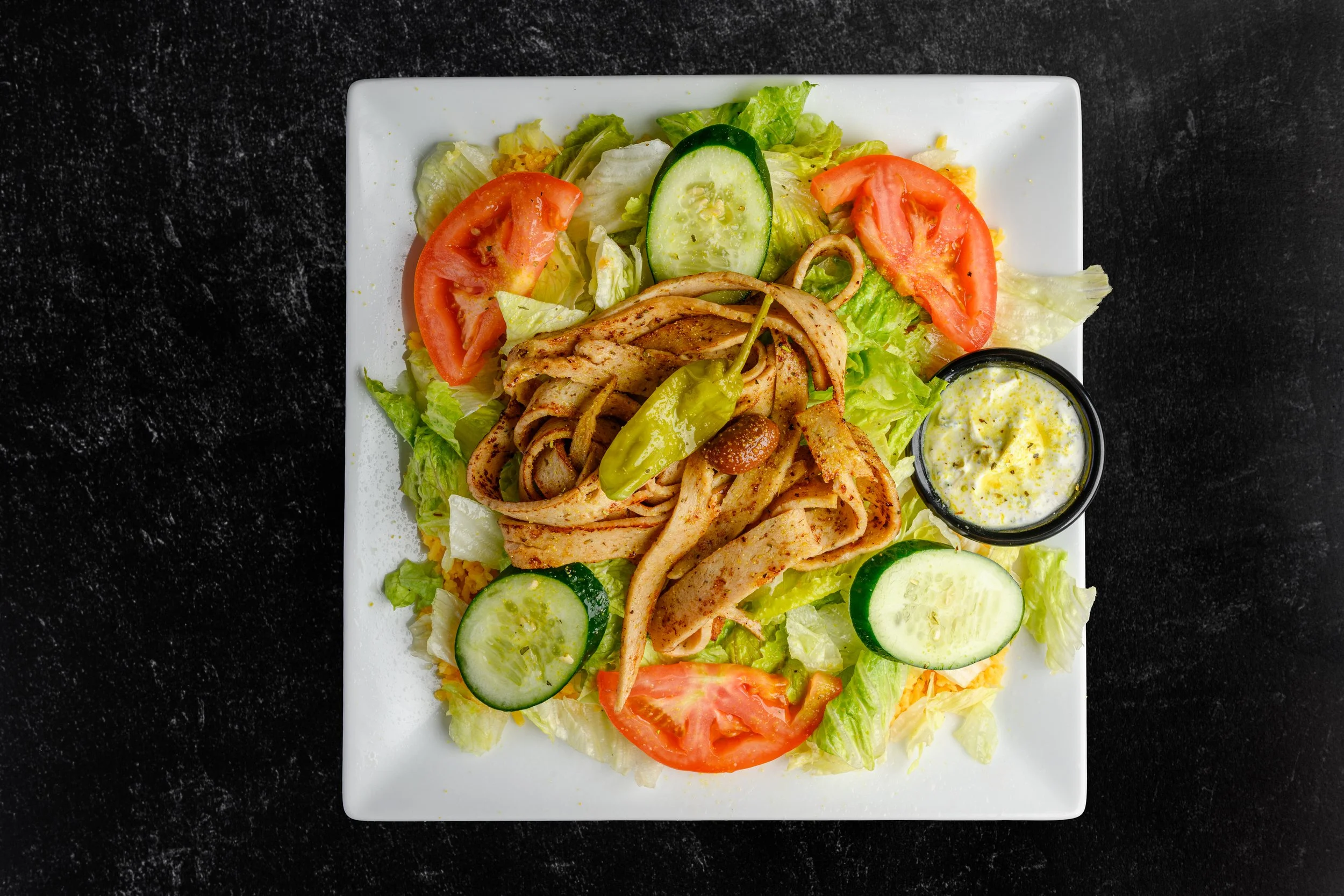 || #6 CHICKEN GYRO SALAD || Bed of Rice + Layered with Iceberg Lettuce + Cucumber + Tomato + Topped with Chicken Gyro Meat + Pepperoncini + Unpitted Greek Olive + W/ House Made Greek Dressing + Comes with Tzatziki Sauce 