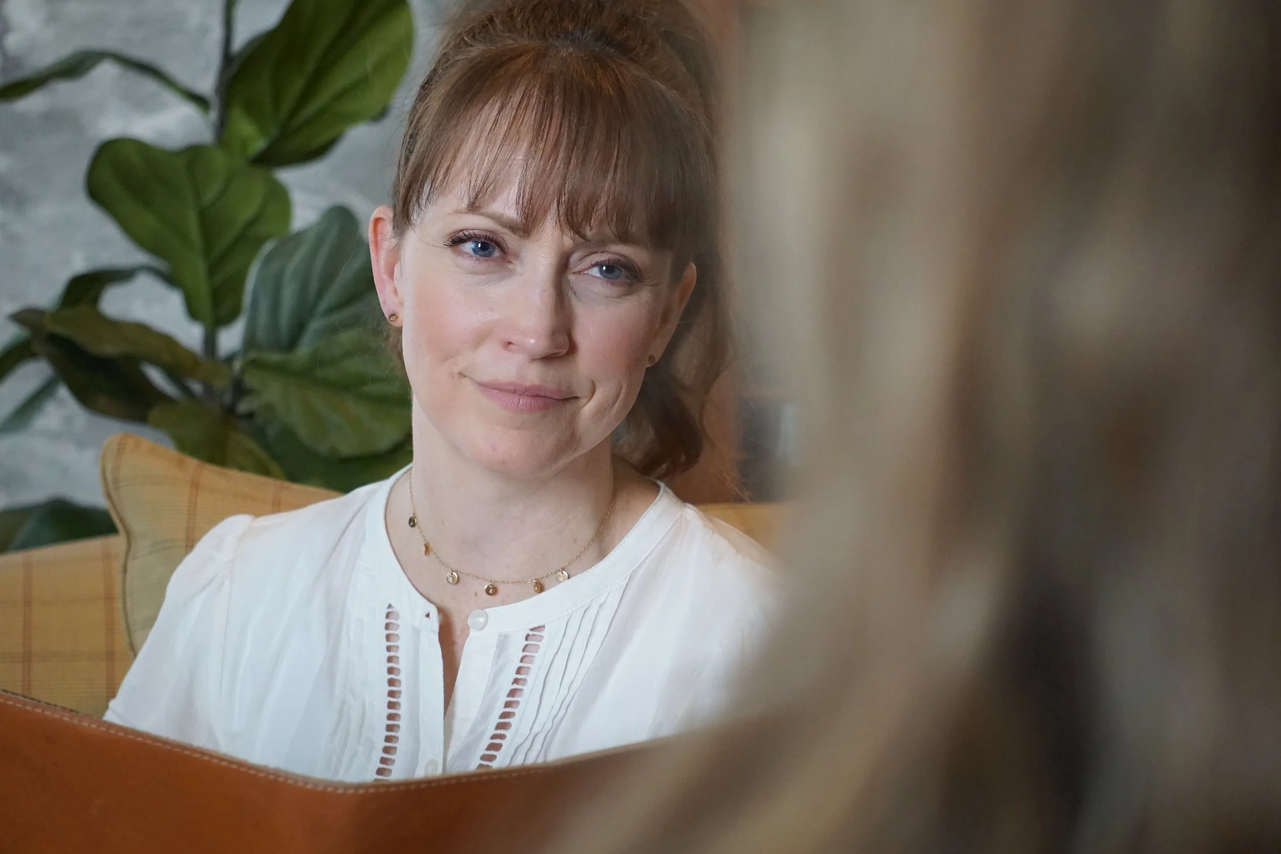 Stacey Haslam listening during a conversation in her office