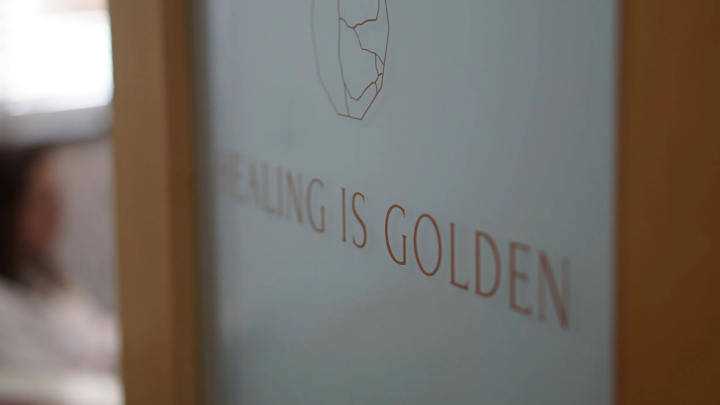Visit the Healing is Golden office - an image of an open therapy office door with the words "Healing is Golden" on it.