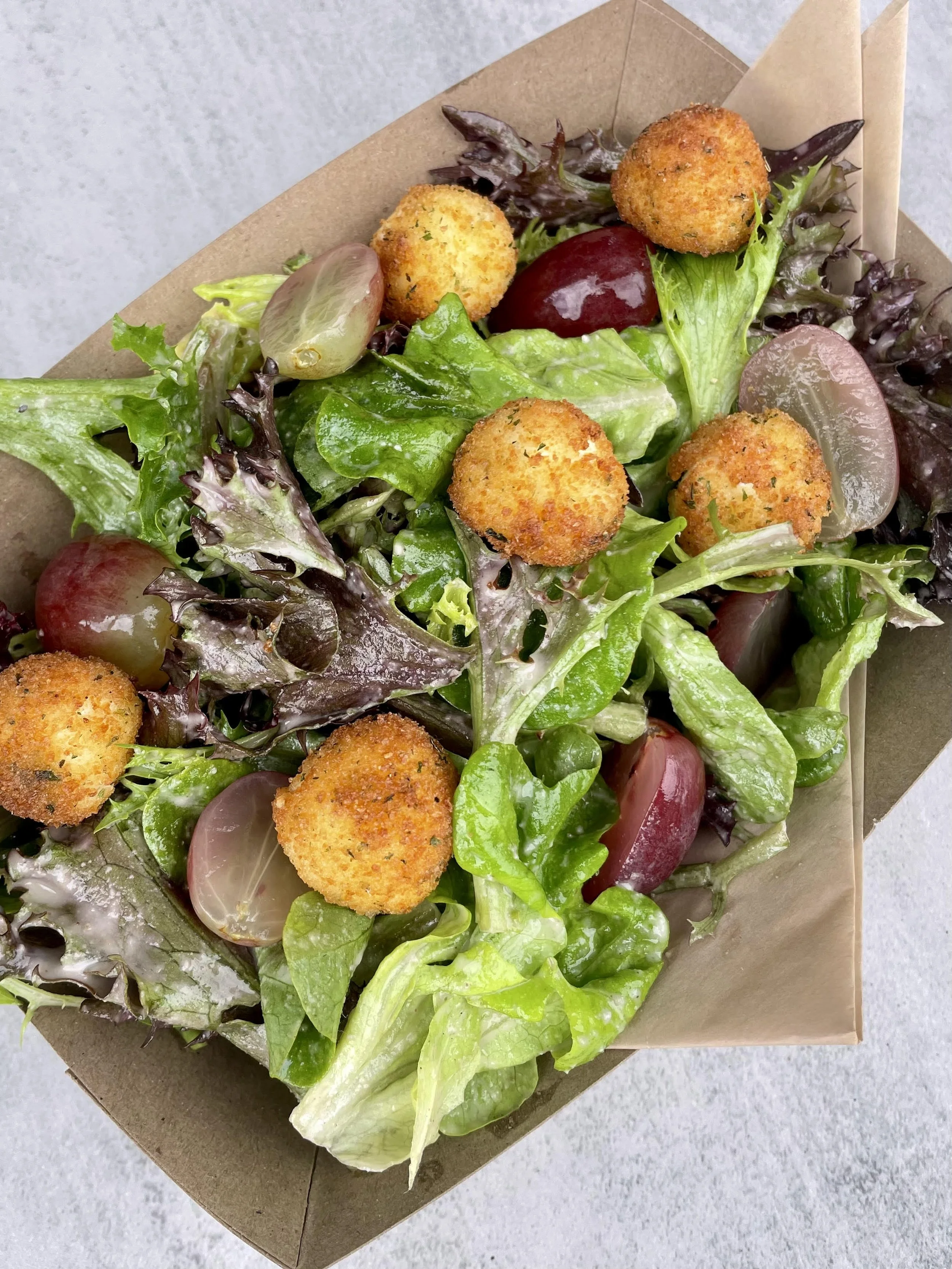sungrounded farm mixed greens, pickled grapes, gluten free crispy goat cheese balls, walnut dressing