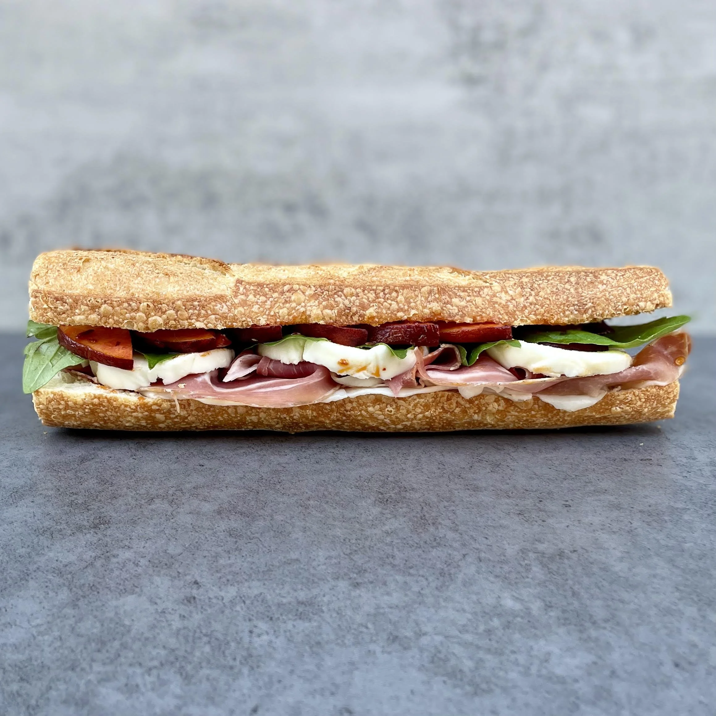 prosciutto, peaches, chili crisp, fresh mozzarella, basil, toasted local baguette