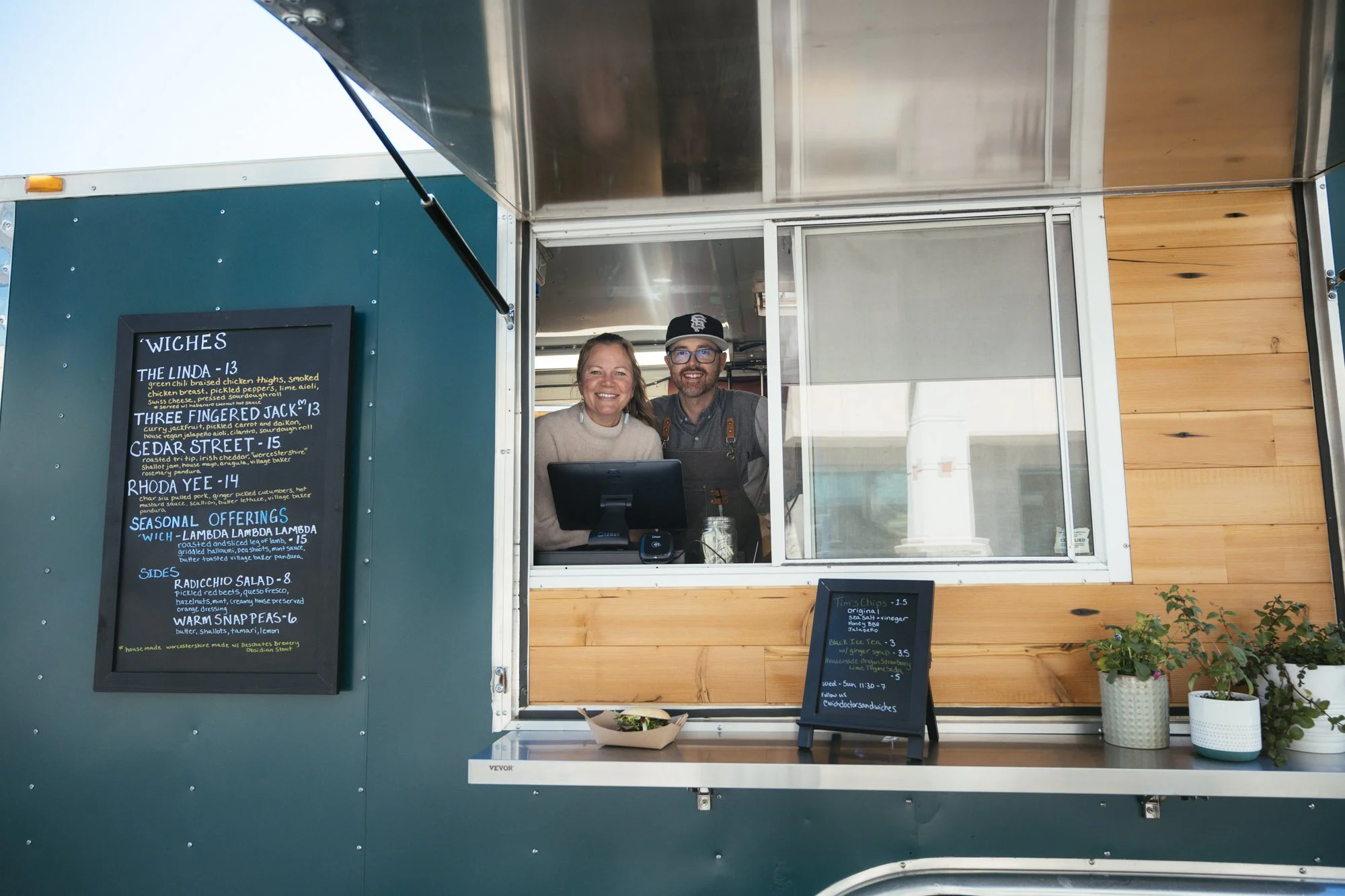 brenda and cody in their delicious sandwich food truck in bend oregon