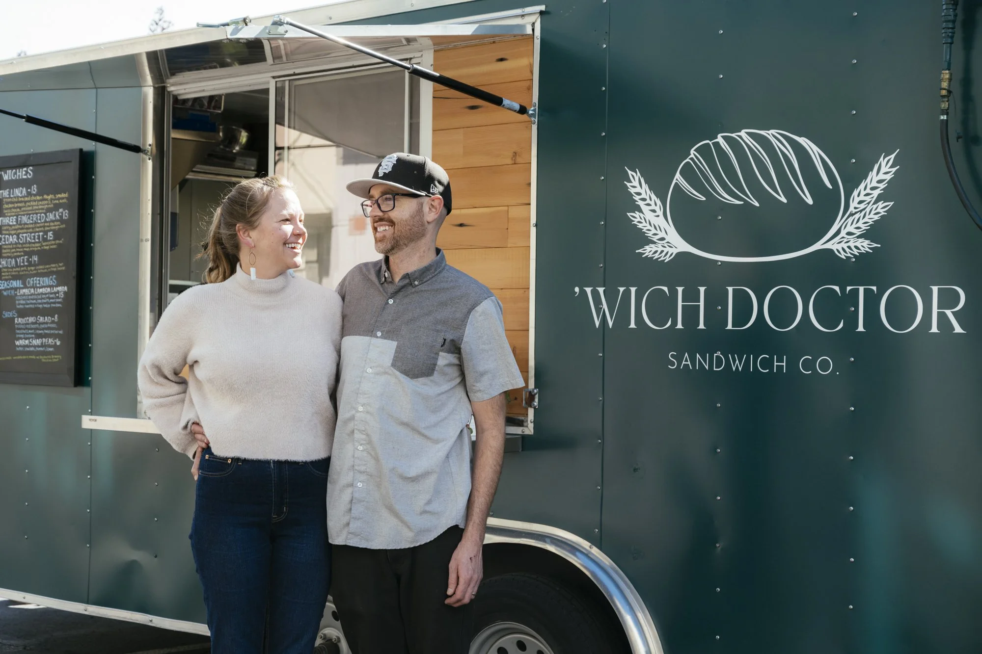 brenda and cody owners of wich doctor sandwich co in front of their food truck
