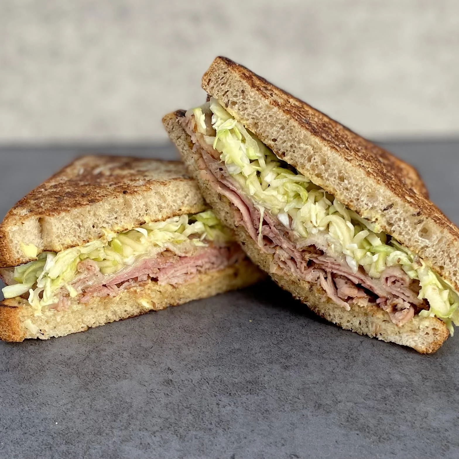 house cured and smoked pork pastrami, apple and cabbage slaw, gruyere, dijonnaise, butter toasted sparrow bakery jewish rye