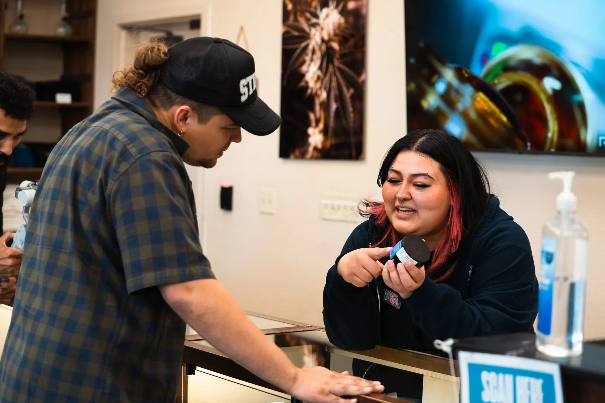NuWu North budtender shows a customer products available for sale at NuWu North