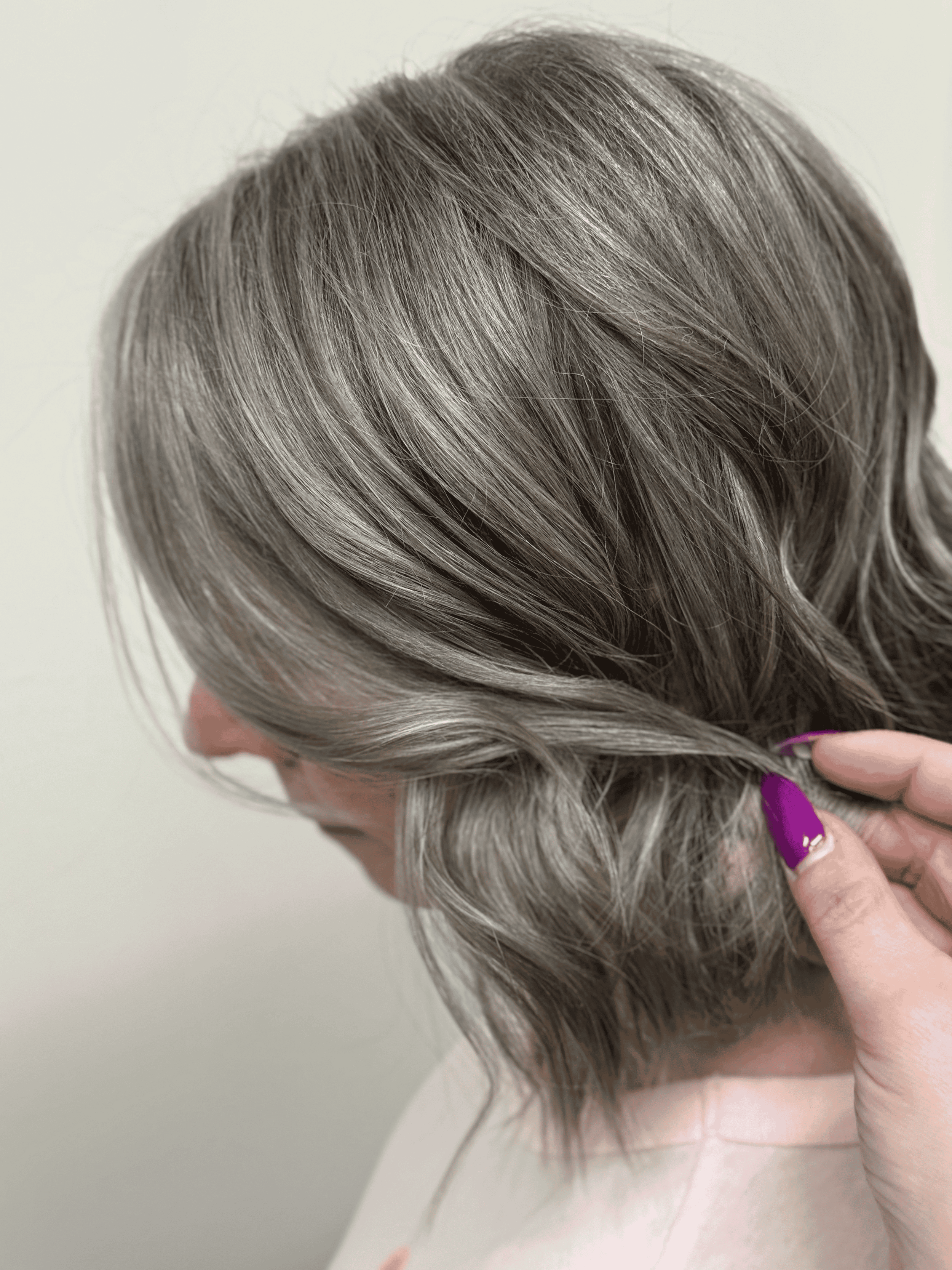 Short choppy angled bob with grey blending at Grace + Grit Salon Studio in Mishawaka, Indiana