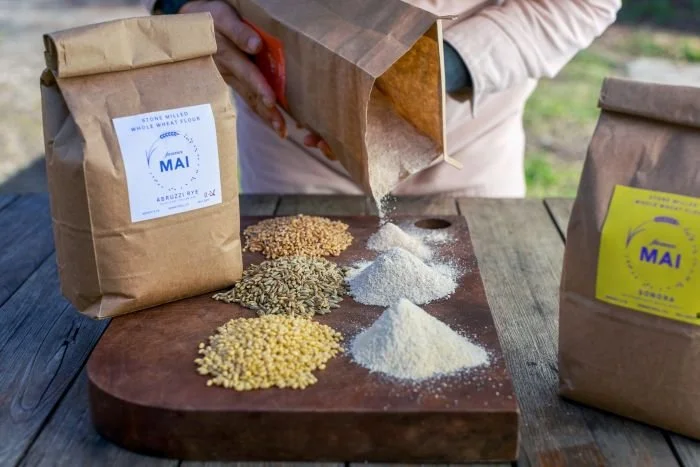 MLM2601-grains-farmer-mai-pours-flour-flight.jpg
