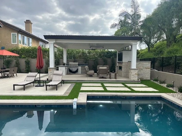 After photo of the patio cover, pool and new hardscape. We used a combo of concrete with a paver boarder and turf to add contrast and pop of color. 