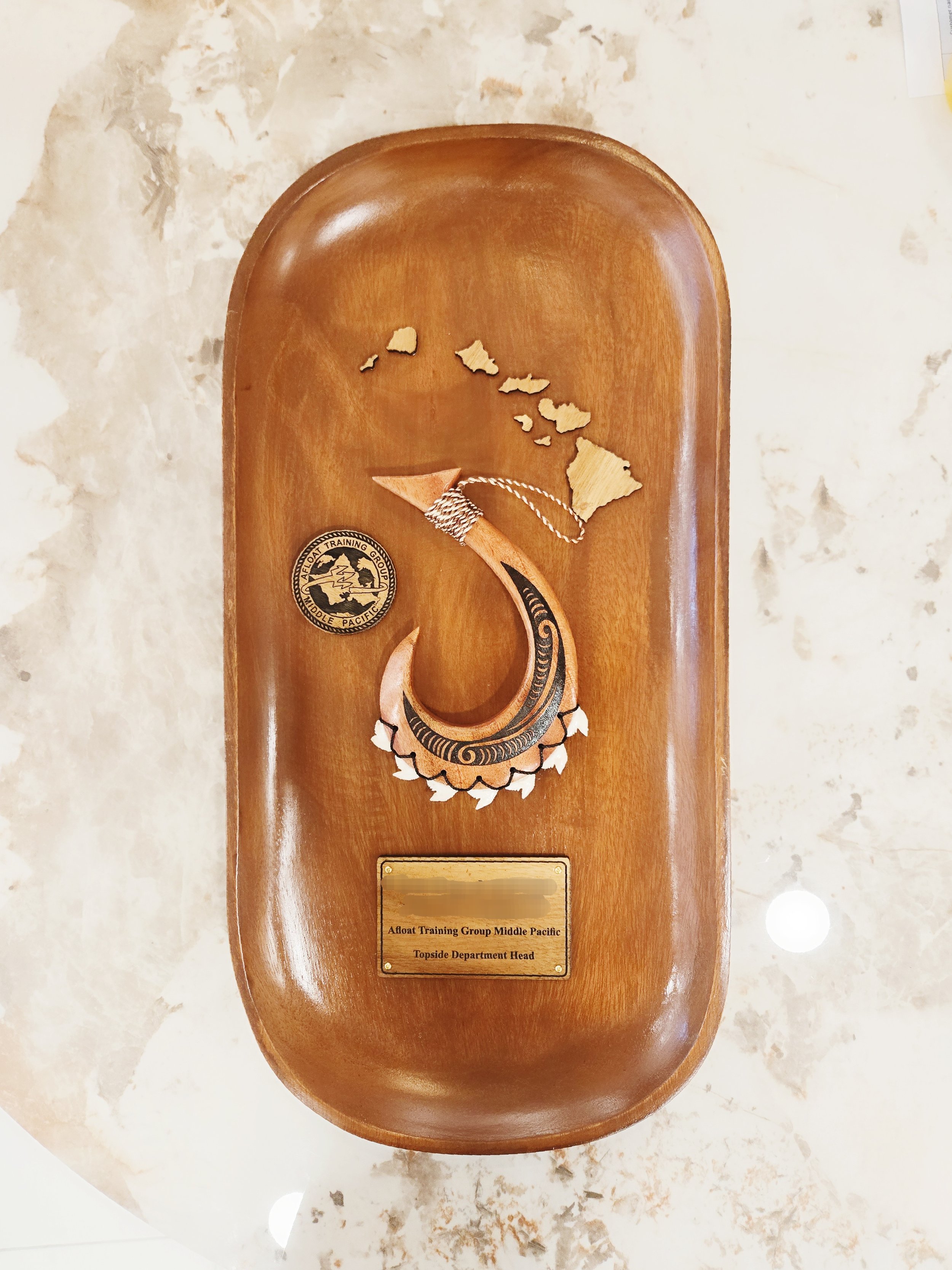 17"×10" Oval Wood Plaque with a mini weapon with a Tribal design, islands, a coin and a wood plate