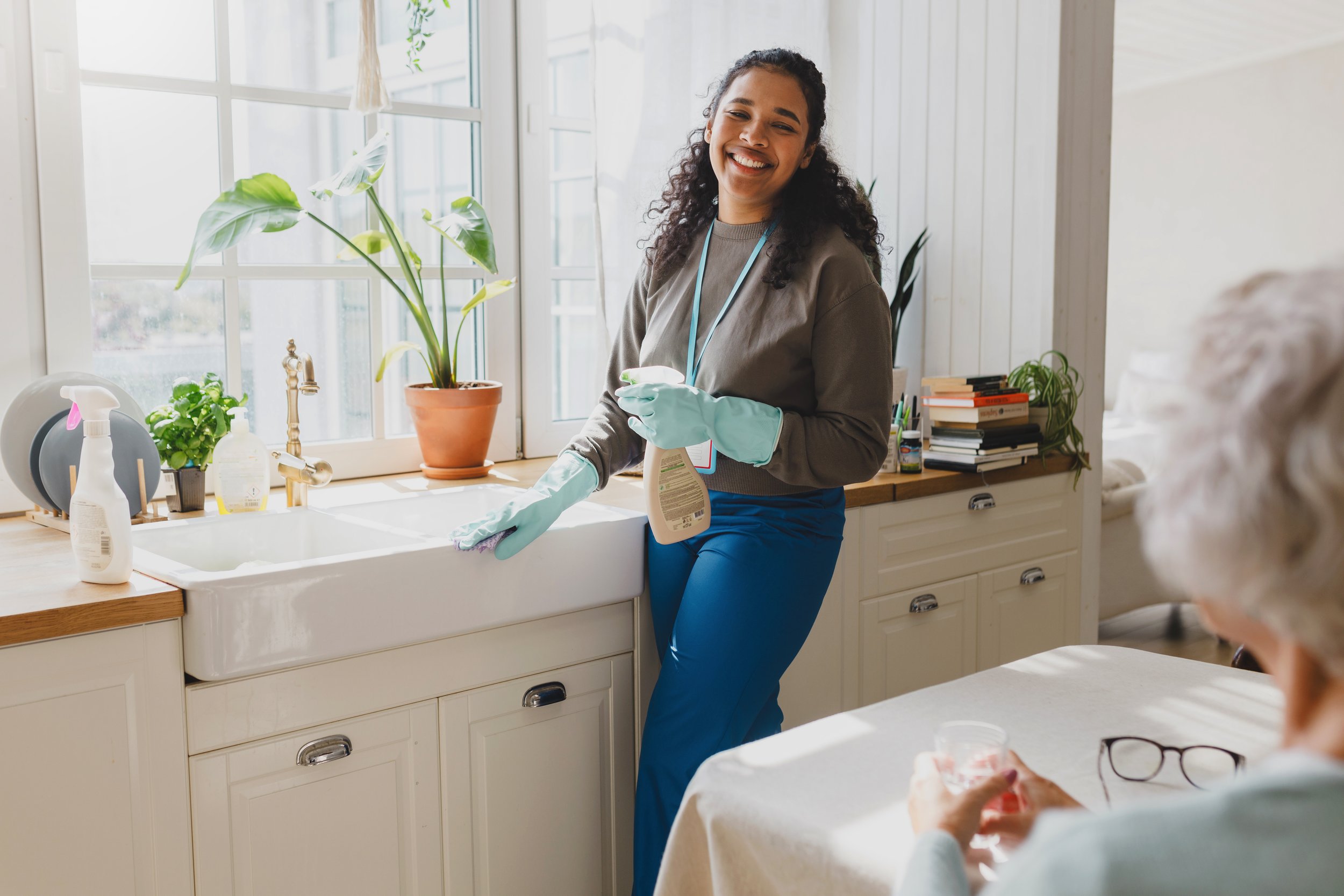 Professional caregiver providing in-home senior care services in Phoenix, Arizona, assisting an older adult in a clean and comfortable home.