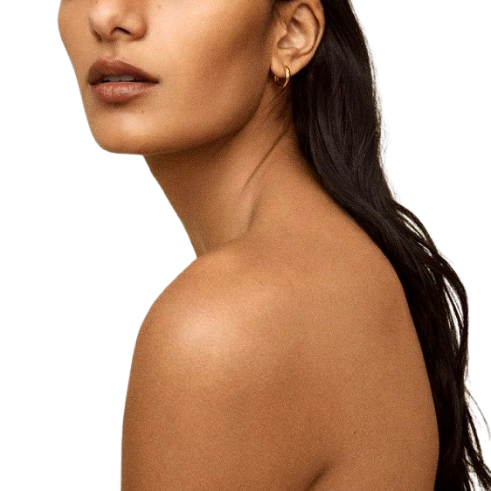 Close-up of a woman's lower face, neck, shoulder, and upper arm with earrings and smooth skin.