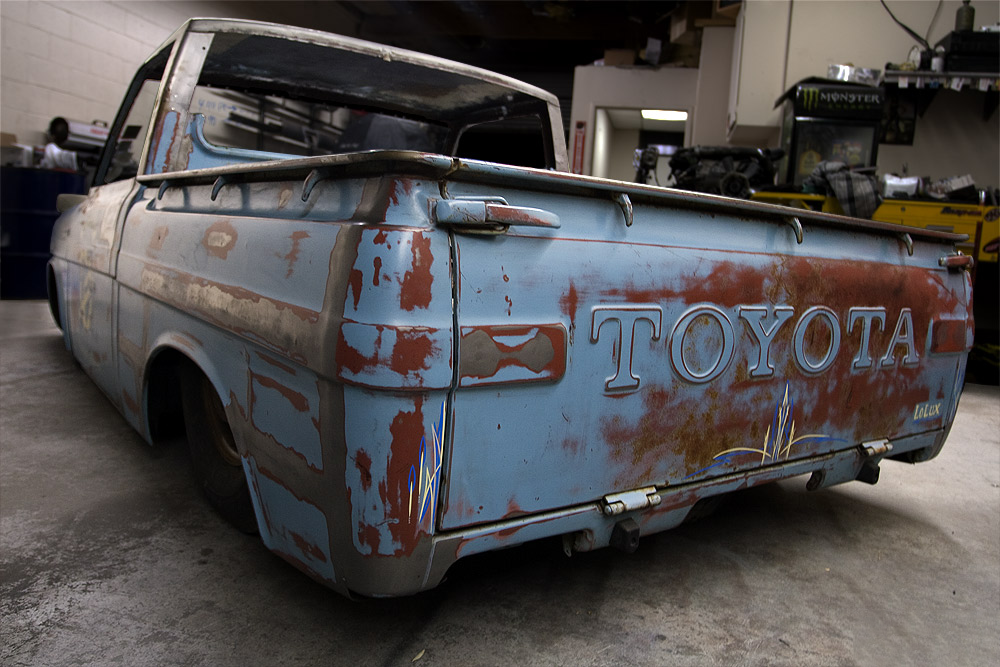 Rusty blue Toyota truck in garage, heavy patina