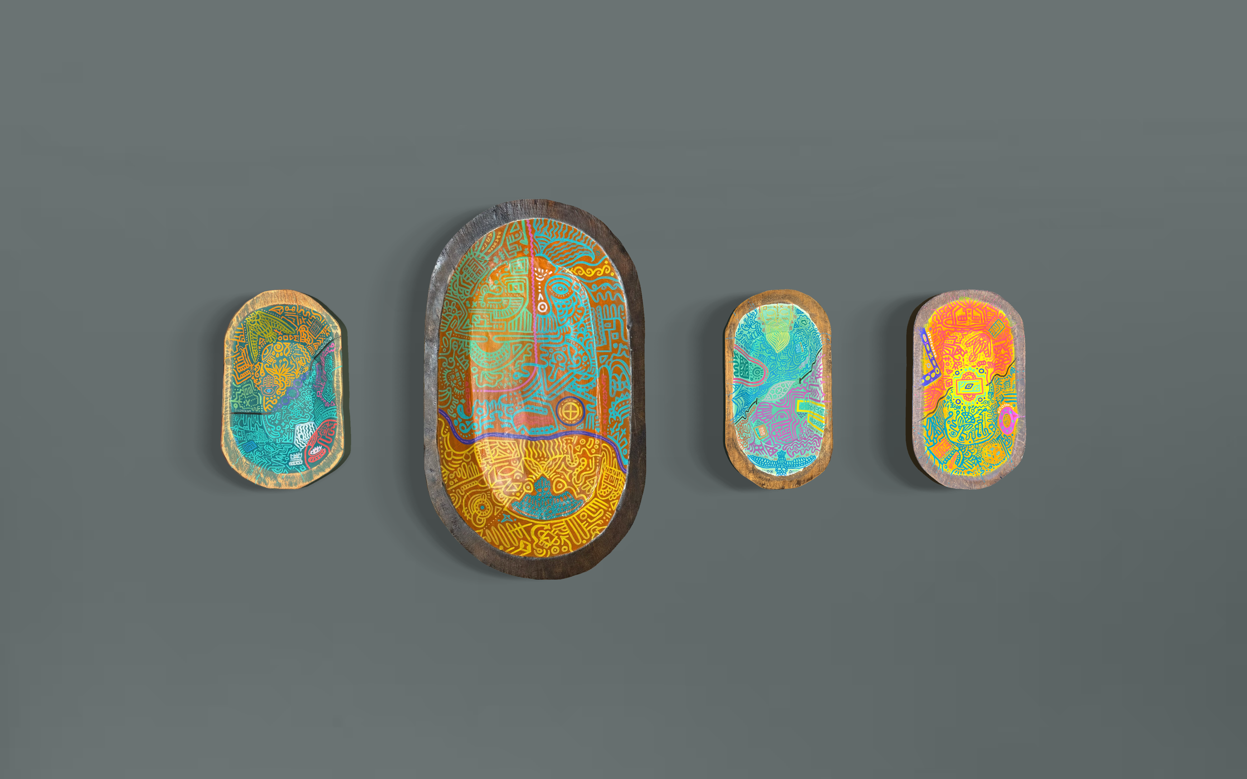 Four decorative oval wooden dough bowls with colourful, intricate tribal patterns, arranged in a row from smallest to largest.